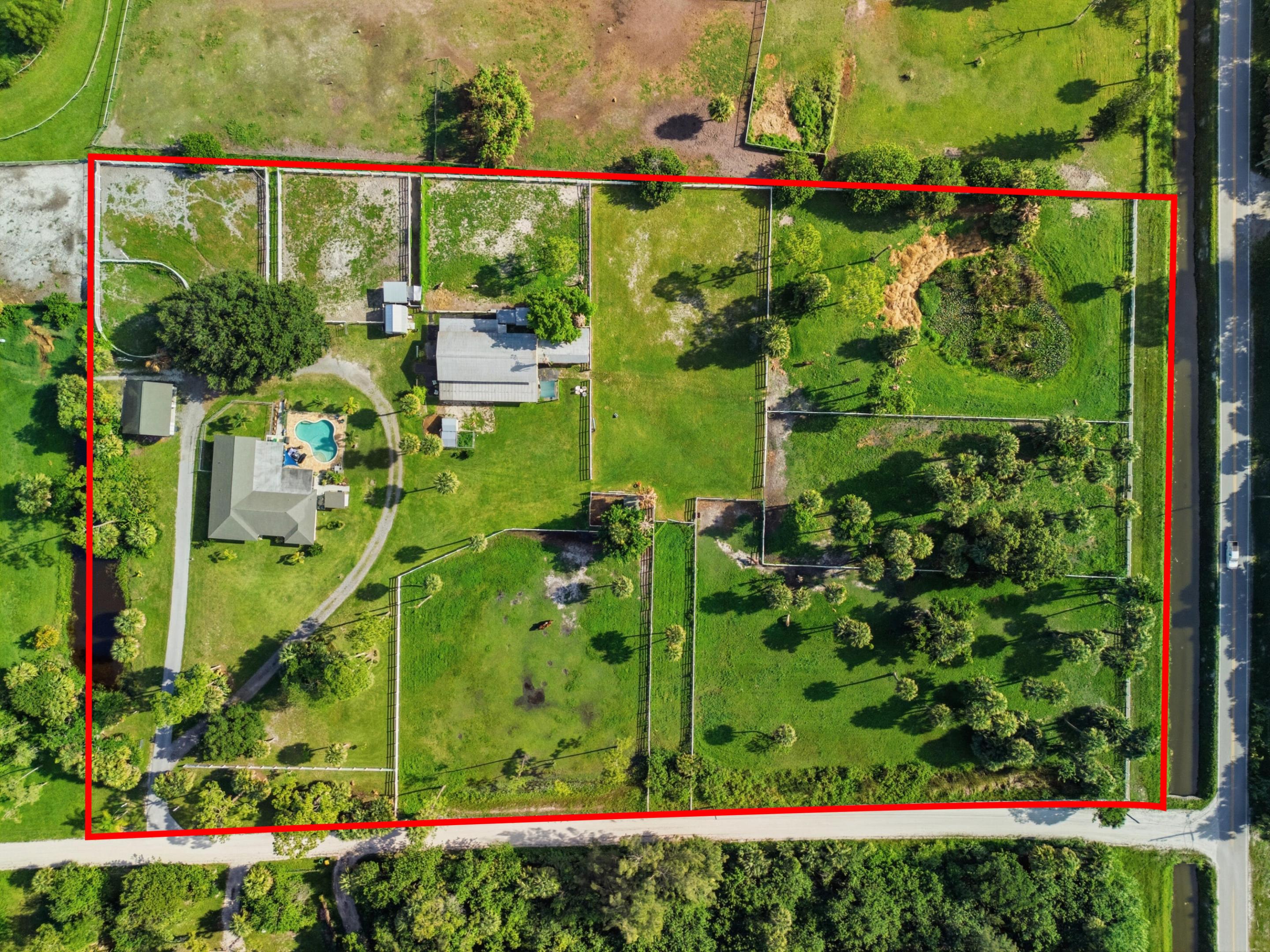 Discover a rare equestrian opportunity on six acres in the heart of Loxahatchee Groves. Designed with horse enthusiasts in mind, the property features nine spacious paddocks, a 12-stall barn and a large grass riding arena that offers excellent potential for conversion into a sand arena. The four-bedroom, three-bathroom residence includes a private pool and generous outdoor space for enjoying the South Florida lifestyle. With some vision and thoughtful updates, this property could be transformed into an exceptional equestrian estate. Its desirable location, substantial acreage and existing equestrian infrastructure make it a true hidden gem with tremendous potential. Bring your horses, your ideas and a little love to create something truly special.