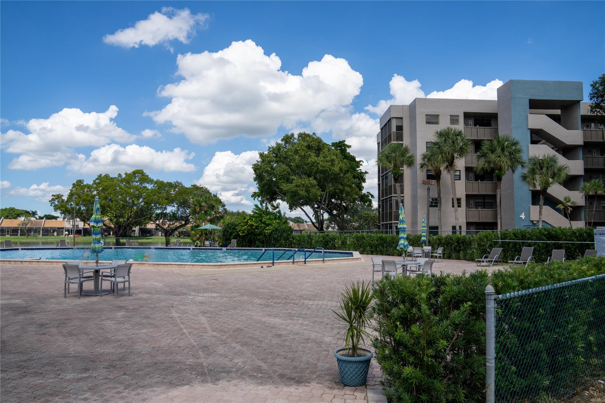 PRICED TO SELL in the heart of Pembroke Pines. Some photos digitally enhanced and virtually staged. This second floor unit is a wonderful opportunity for someone with the right vision to update and personalize to their style and preference. Enjoy a quiet, guard-gated, 55+ community with private balcony overlooking a serene lake. Residents can relish in resort-style amenities including a heated pool, spa, tennis courts, fitness center, billiards room, theater, and so much more. Ideally located near Pembroke Lakes Mall, restaurants, shops, major highways, Memorial Hospital and the community is on the hospital power grid, ensuring power even during outages. Can't beat this offer to create your new home with all the comforts and conveniences of an unbeatable lifestyle.