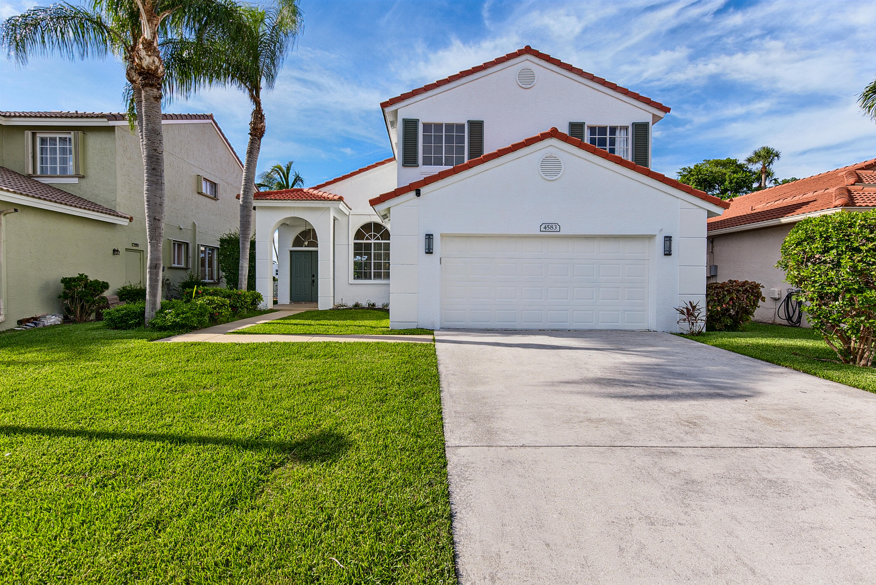 **Rarely available 4-bedroom home with a first-floor primary suite, oversized fenced backyard, and peaceful Hillsboro Canal views! Offering exceptional privacy with no rear neighbors, this beautifully maintained home features soaring two-story ceilings and abundant natural light that create a bright, open atmosphere. Elegant travertine flooring enhances the main living areas, while the updated kitchen boasts granite countertops, stainless steel appliances, and opens seamlessly to the family room, creating the perfect space for everyday living and entertaining. The spacious first-floor primary suite features wood flooring, sliding glass doors to the backyard, a large walk-in closet, and a beautifully updated en-suite bath with a soaking tub and separate shower. Upstairs, you'll find  three additional bedrooms and a full bath, providing plenty of space for family, guests, or a home office. Additional highlights include a two-car garage, no carpet or popcorn ceilings, and lawn maintenance included. Step outside to the expansive fenced backyard overlooking the canal—an ideal setting for relaxing, entertaining, or letting pets play. Pets are welcome with owner approval and a pet deposit. Residents also enjoy access to the community pool and the convenience of nearby shopping, dining, parks, major highways, and highly rated school zones. A wonderful opportunity to enjoy the privacy, space, and convenience of South Florida living in a beautifully maintained community.  Hot tub will be excluded from lease.