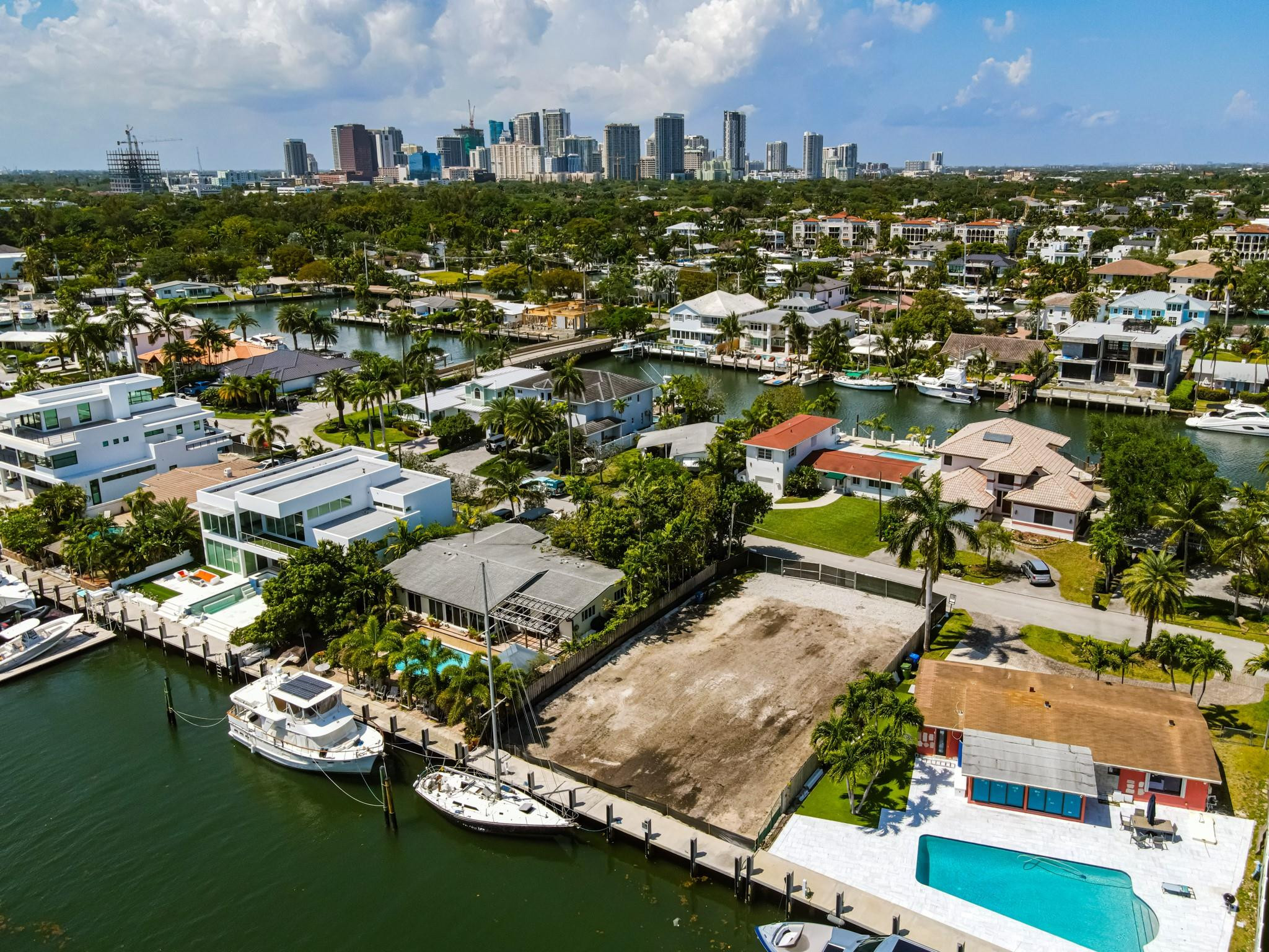 NO FIXED BRIDGES! Enjoy 70 feet of waterfront on the south side of the street with direct, unrestricted ocean access—just minutes to open water. This south-facing property offers refreshing breezes and is ideally located near the beach, international airport, downtown, shopping, and major highways. Build your dream home here!The property is being sold AS-IS, and plans are included in the sale. The land is vacant and fully fenced.DO NOT WALK THE PROPERTY. Agents must accompany all buyers. NO ShowingTime requests—please call or text to schedule. Information published or otherwise provided by the listing company and its representatives including but not limited to prices, measurements, square footages, lot sizes, calculations, statistics, and videos are deemed reliable but are not guaranteed and are subject to errors, omissions or changes without notice. All such information should be independently verified by any prospective purchaser or seller. Parties should perform their own due diligence to verify such information prior to a sale or listing. Listing company expressly disclaims any warranty or representation regarding such information. Prices published are either list price, sold price, and/or last asking price. The listing company participates in the Multiple Listing Service and IDX. The properties published as listed and sold are not necessarily exclusive to listing company and may be listed or have sold with other members of the Multiple Listing Service. Transactions where listing company represented both buyers and sellers are calculated as two sales. No payments made until title passes Some affiliations may not be applicable to certain geographic areas. If your property is currently listed with another broker, please disregard any solicitation for services. Information published or otherwise provided by seller, listing company or its representatives is deemed reliable but are not guaranteed and subject to errors, omissions, or changes without notice. Copyright 2026 by the listing company. All Rights Reserved