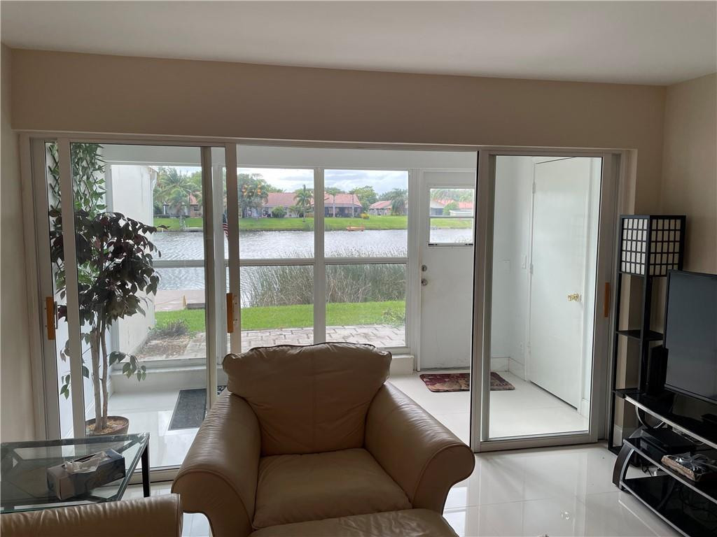 Spectacular water views and sunsets from this beautiful first floor unit.  Back yard faces Rainbow Lakes over looking boats and single family homes.  Unit has been updated with 42" white shaker cabinets, soft close cabinets, lazy susan, large pantry and Samsung appliances. No walls in kitchen and Living room, total lake views thru out the condo. Quartz counter tops with extended breakfast bar, Barn door covering washer and dryer unit.24 x 24 porcelain tile and wood like in both bedrooms. Patio is enclosed and there is also an open outdoor living area for a barbecue. new AC, accordian shutters. Beautiful unit just minutes to downtown Atlantic ave. Close to beach and 95. Two comunnity pools, Tennis courts and clubs with activities. spectacular first floor unit perfect place to retire.