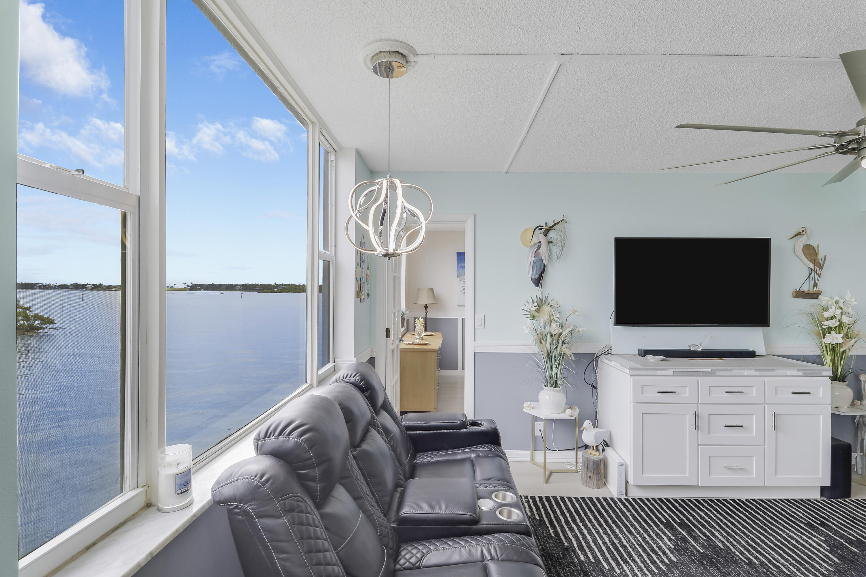 Welcome to effortless waterfront living in this beautifully renovated 2-bedroom, 2-bath residence offering stunning unobstructed Intracoastal views from the main living areas and bedrooms. Thoughtfully updated from top to bottom, this move-in ready condo combines coastal charm with modern convenience in one of the area's most desirable waterfront communities.  Recent improvements include a roof replacement, exterior building painting, and impact windows along the water-facing side for added peace of mind and energy efficiency. The building also offers the convenience of washer & dryer facilities on every floor.  Residents enjoy a low-maintenance lifestyle with building insurance, central water, grounds maintenance, assigned parking (#54 closest to the entrance). Relax by the Intracoastal waterfront pool while enjoying breathtaking water views and coastal breezes. Seacrest Villas is a desirable 55+ community ideally located near beaches, dining, shopping & entertainment — offering the best of the Florida waterfront lifestyle.