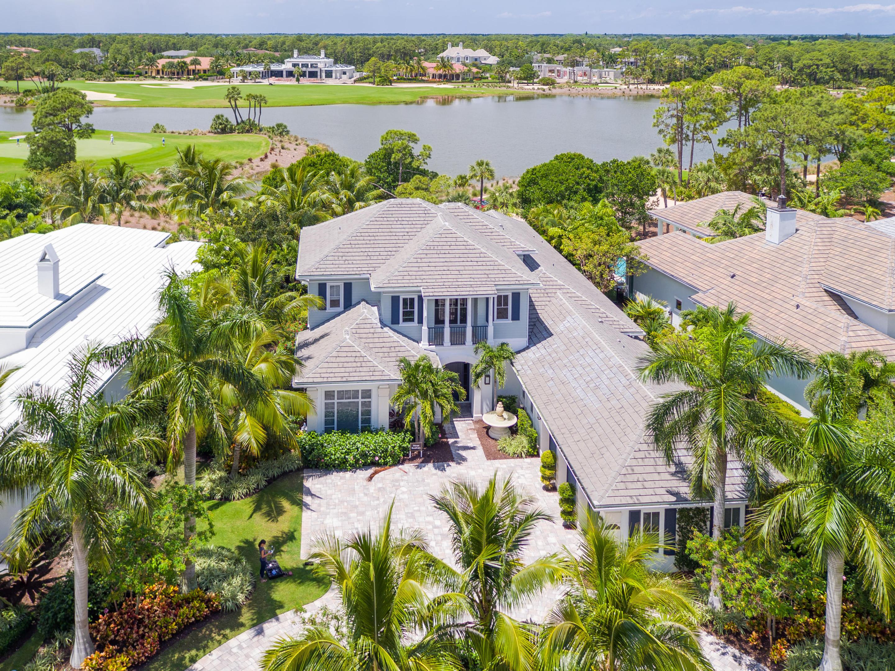 Best spectacular water and golf views in Old Palm from this luxurious, top-of-the-line, beautifully decorated, 5BR/5.2BA + office/entertainment center + loft, 5765-sq.ft. British West Indies, newer 2014/2015 construction, former model home. Highly sought-after features include soaring tray ceilings with crown molding, living room fireplace, oak hardwood & marble floors, massive windows and wall-to-wall sliding glass doors, a glass-enclosed walk-in wine cellar, a spacious master suite with separate His & Hers baths and walk-in closets, an amazing gourmet kitchen with waterfall quartz countertops and side-by-side chest-high Wolf ovens with a microwave in between, and an extraordinary outdoor oasis complete with a pool, spa, outdoor kitchen, and fire pit, all overlooking the golf course.