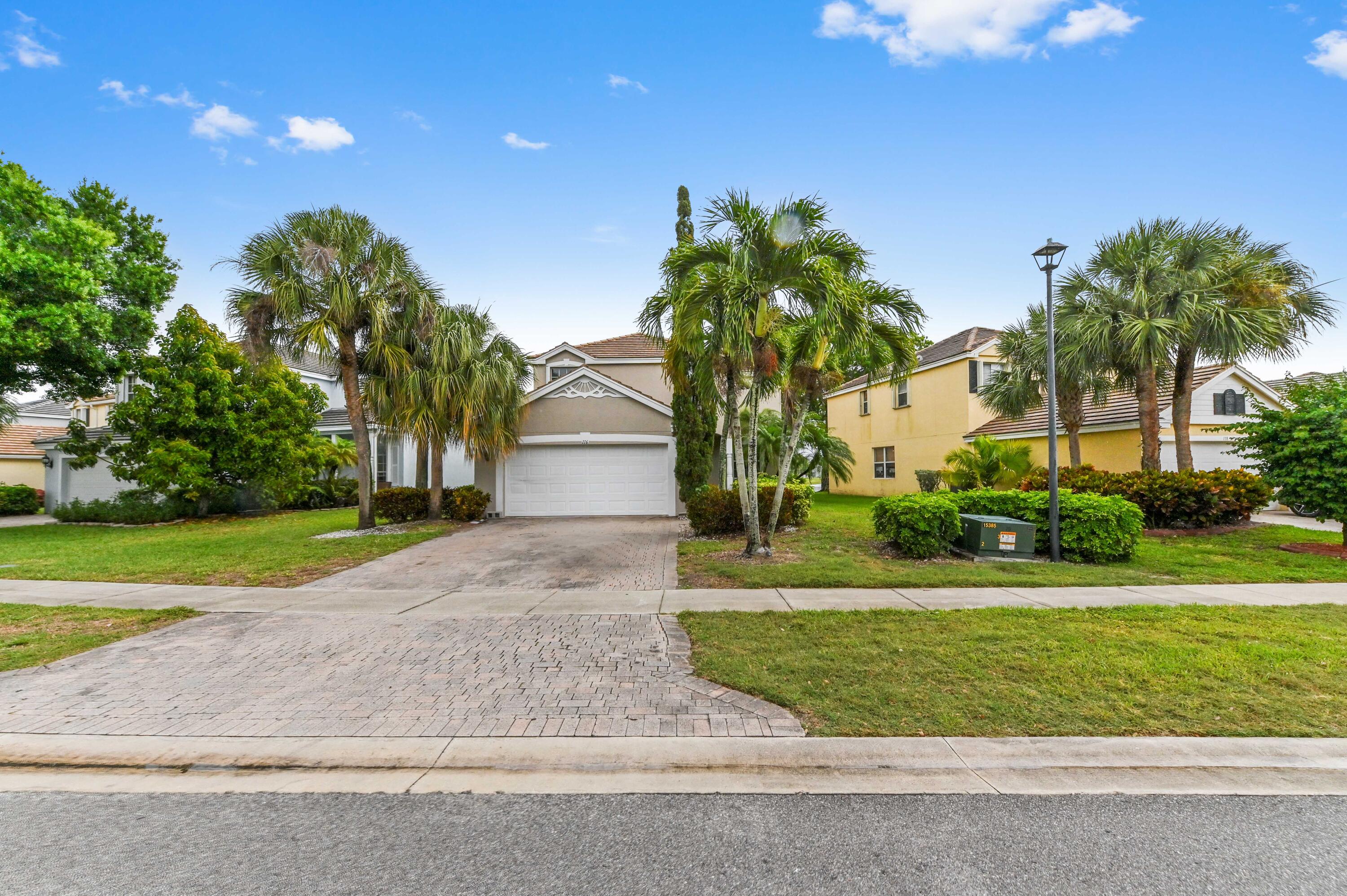 Welcome to 116 Hamilton Terrace, a beautifully maintained lakefront home nestled within a sought-after gated community in Royal Palm Beach. This inviting residence offers generous living spaces filled with natural light, complemented by a spacious eat-in kitchen featuring abundant cabinetry and a seamless flow into the warm, welcoming family room—perfect for everyday living and entertaining. Step outside to a tranquil patio where peaceful lake views create the ideal backdrop for morning coffee or evening relaxation. Each bedroom is thoughtfully sized, while the primary suite serves as a true retreat, complete with a luxurious en-suite bath and a soothing Roman tub. Beyond the home itself, residents enjoy access to an array of resort-style amenities including a clubhouse, sparkling pool and spa, fitness center, tennis courts, and recreational areas for all ages. Located within a highly regarded Wellington school zone, this home also offers unbeatable convenience with close proximity to major highways, premier shopping and dining destinations, nearby international airports, and South Florida's stunning beaches. This is more than just a home—it's a lifestyle defined by comfort, community, and scenic beauty.