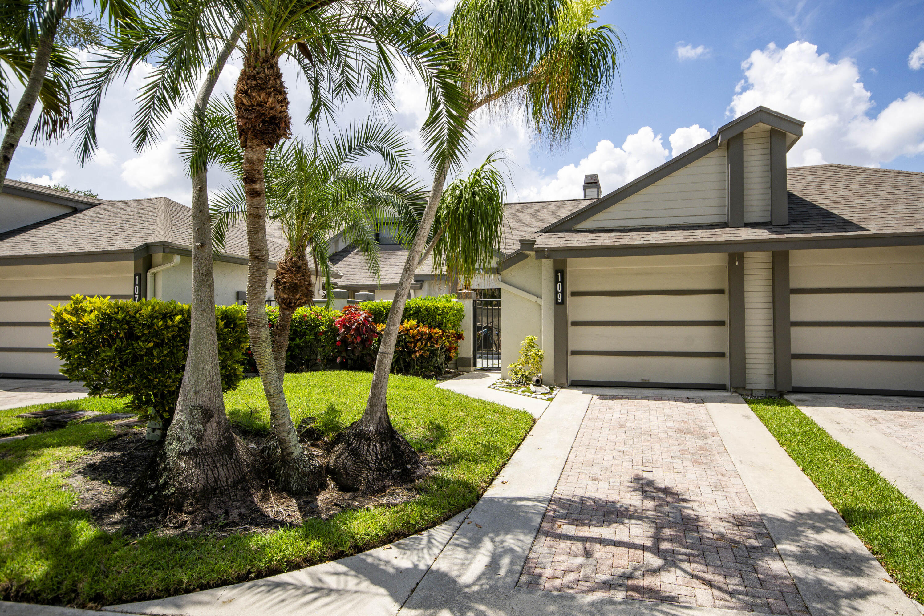 Updated, bright and move-in-ready villa in Landings at River Bridge featuring an open split-bedroom layout, a 2025 roof and new 2026 A/C. The renovated kitchen offers custom tile flooring, a stylish backsplash and coffee bar, while the living and dining areas feature laminate wood floors, crown molding and a fireplace. The spacious primary suite opens directly to a refurbished private deck with peaceful lake views, ideal for grilling and entertaining. Additional upgrades include updated bathrooms and a new washer. Enjoy 3 pools, tennis, pickleball, bocce, shuffleboard, fitness and billiard rooms, a lakefront spa, game room and movie room, all near Okeeheelee Park, shopping, dining, highways and the airport.