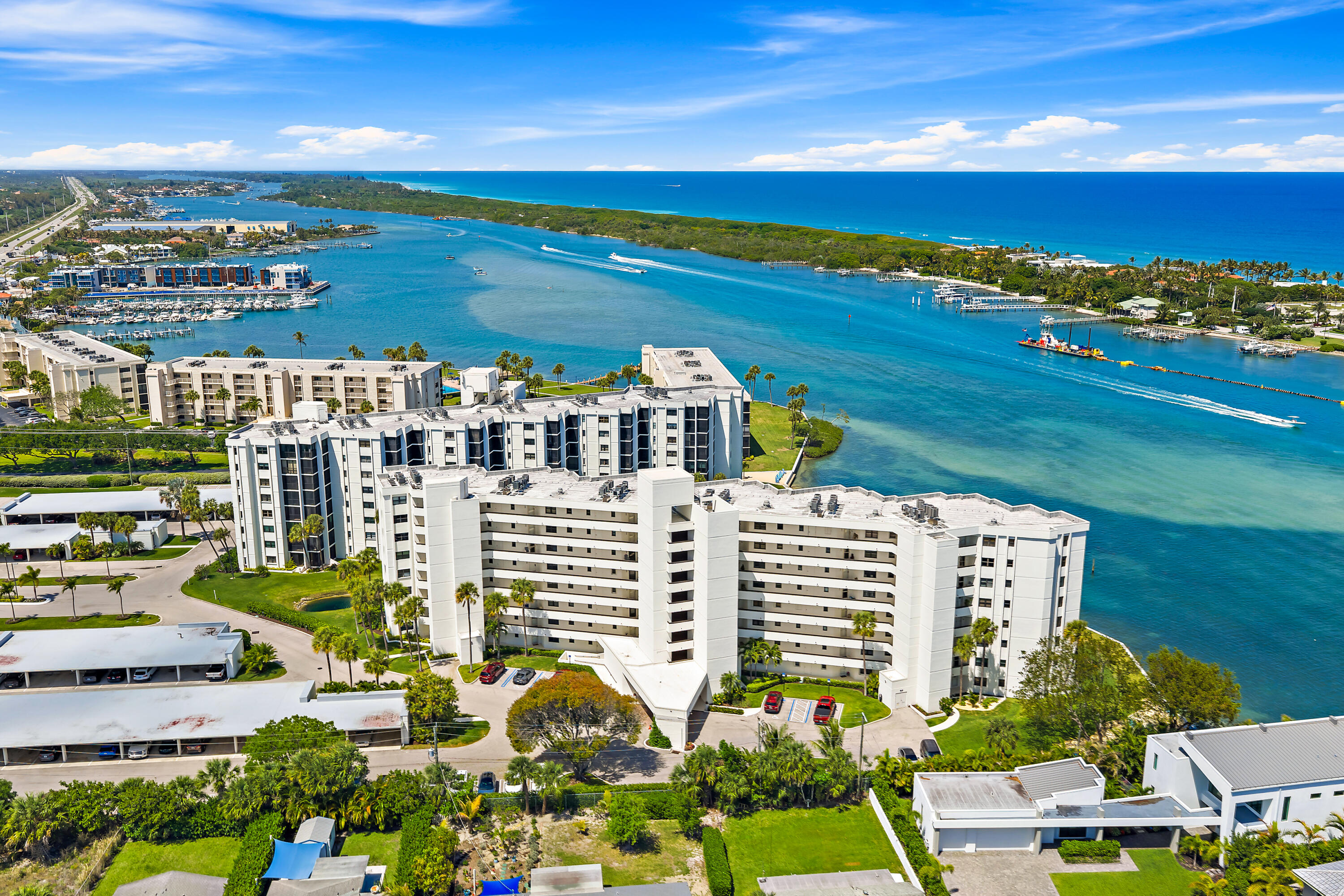 With panoramic views of both the turquoise Intracoastal waters and a serene lake, this 2-bedroom, 2.5-bath condo in Sandpointe Bay offers the best of Tequesta waterfront living. Natural light fills the open living spaces, complemented by vinyl plank flooring throughout the main areas, creating a clean, cohesive feel.  Both bedrooms are en suite, and all bathrooms—including the powder room—have been recently updated with a fresh, modern look. Impact glass throughout provides peace of mind, along with major system updates including a 2023 HVAC and 2022 hot water heater—taking care of the big-ticket items.  The primary suite and main living area both open to the balcony, offering water views and the perfect setting to enjoy the coastal breeze and sunrise skies.  The kitchen features  white cabinetry and granite countertops, offering a bright and functional space that blends seamlessly with the living areas. Sandpointe Bay offers a pool, clubhouse, spa, tennis courts, and a day dock for residents—delivering a true waterfront lifestyle in a prime Tequesta location.