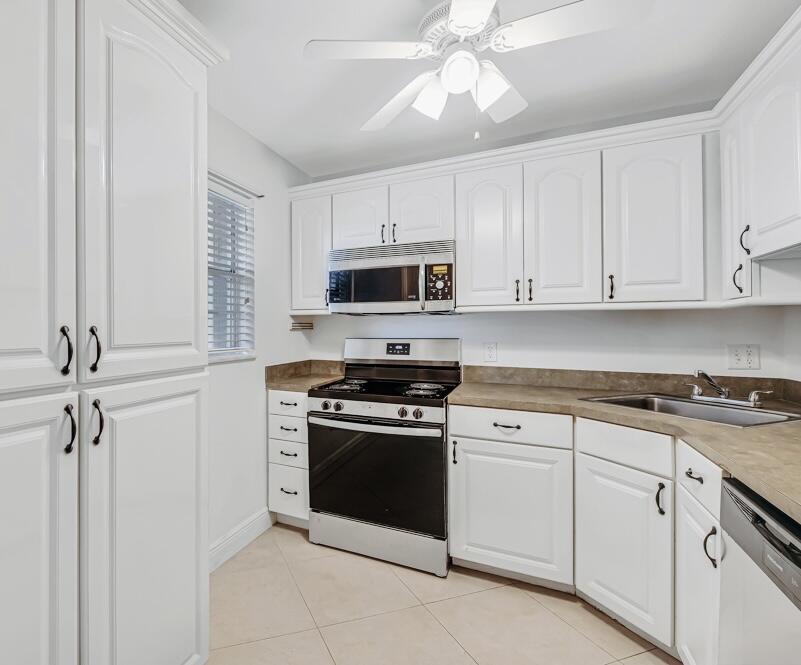 Welcome to this newly renovated, move-in-ready first-floor condo located in the desirable 55+ community of Greenway Village South in Royal Palm Beach. The inviting residence offers comfortable living with a spacious floor plan and a private screened-in patio, perfect for enjoying Florida's lifestyle. This beautifully renovated home offers NEW AC, NEW WATER HEATER, NEW STAINLESS STEEL KITCHEN APPLIANCES, NEW BATHROOM VANITIES, NEW FLOORING, and much more! Additional highlights include accordion shutters on all windows and doors, as well as a newer roof! Greenway Village offers Cable, Water, Pest Control, Clubhouse, Fitness Center, Pool, Shuffleboard, and Library.  Located just minutes from top-rated dining, shopping, parks, and major highways. Whether you're looking  for a seasonal retreat or a full-time residence, this charming condo is ready for you to make it your own. Don't miss this chance—schedule your private showing today!