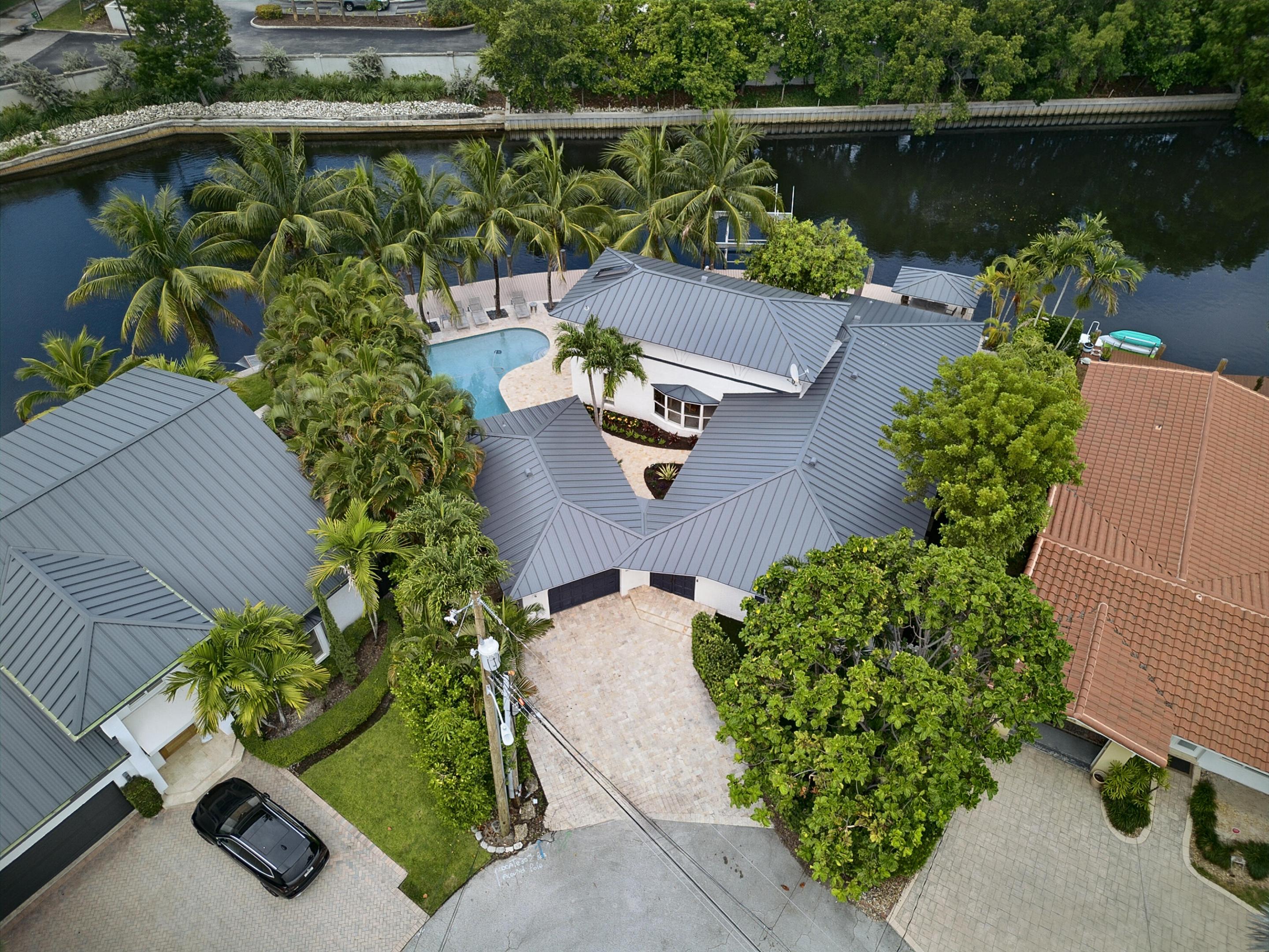 Exceptional waterfront opportunity on a quiet cul-de-sac in East Wilton Manors with spectacular wide water views of the South Fork of the Middle River. This private retreat offers 125 feet of waterfront with a composite dock, boat lift, lovely pool, and endless views. A second-floor loft with a private balcony provides ideal space for an office, studio, or guest suite. The detached one-car garage includes a full cabana bath and additional storage room. The primary bedroom and bath have been beautifully remodeled, and a brand-new metal roof was just installed. Seller has renderings and plans available to complete the renovation and transform this property into a showcase waterfront estate. Enjoy canal views from nearly every rear-facing room and windows designed to capture the setting.