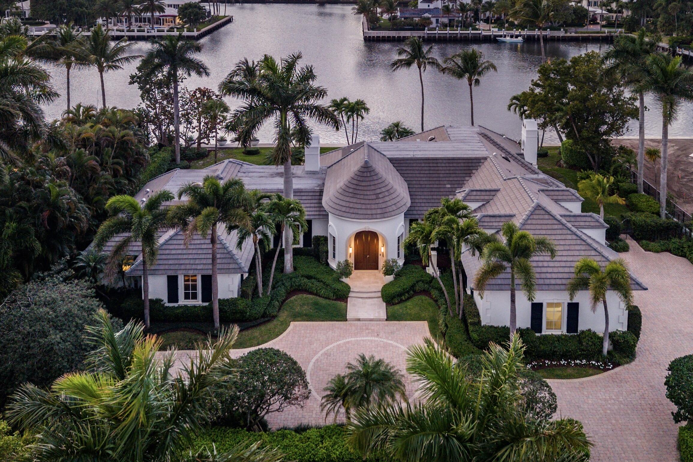 Rarely available Polo Cove exceptional waterfront estate in the heart of Gulf Stream offering 150' of frontage on a protected cove just off the Intracoastal Waterway. Spanning 6,283 total square feet, this residence, designed and rebuilt by Bill Wietsma, features Venetian plaster finishes, richly detailed wood ceilings, and resort-inspired interiors with refined finishes throughout. The residence includes a waterfront living room and family room, each with a fireplace, a formal dining room, and a chef's kitchen with Wolf and Sub-Zero appliances, oversized island, two dishwashers, wine cooler, and warming drawer. Nearly every principal room captures sweeping Intracoastal views.  The home offers a luxurious first floor primary suite, guest suite, second floor private guest suite, and custom office/den. Tropical landscaping frames a private pool and expansive loggia with a fully equipped outdoor kitchen, providing generous space for entertaining or quiet evenings along the water. Ideally located moments from Gulf Stream's beaches and the shopping and dining of Delray Beach and Palm Beach. A rare opportunity to enjoy protected waterfront living in the heart of Gulf Stream.