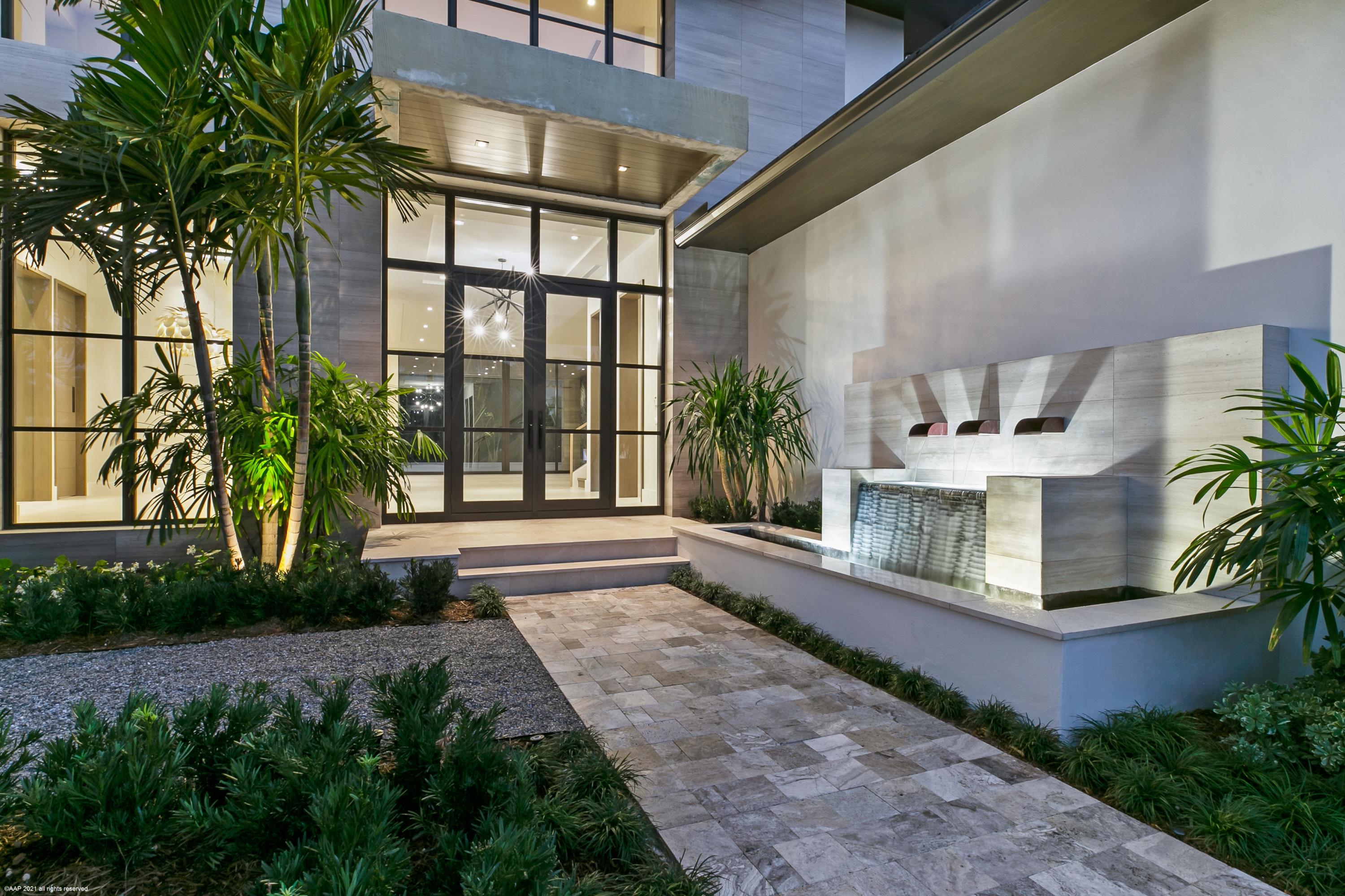 Brand New Contemporary styled home awaits to knock your socks off! A collaborative effort of award-winning masters, who spared no detail; builder Courchene Development Corporation, interior designer Insignia Design, both headed by Paul Courchene & Affinity Architects.

Thoughtful, elegant finishes are featured throughout the sumptuous 5 bedroom, 5 full baths, 1 half bath home totaling 8019 square feet, with 6292 square feet under conditioned air, including the 3-car garage and covered lanai.  This bright, open floor plan is bathed in natural light through expansive windows throughout the home.  The luxuriant detail is finished in warm neutral tones to make you want this home to be your own. ... ... As you enter through the light filled entry doors your views are taken through the expansive foyer, great room and covered lanai to the lushly landscaped rear garden with its gentle waterfall cascading into the spa & pool.  The main floor has all the design elements required to never go upstairs, should that be your desire; a spacious Master Suite with an richly appointed Master Bath, inviting Formal Dining Room, stunning gourmet Kitchen with an adjoining pantry, Breakfast Room, Great Room with beautifully nuanced detailing, which all overlook the gardens & water features. In addition, the Club Room provides a haven for separate TV/video/reading/office tasks which is finished with custom built in cabinetry. A fabulous Powder Room, Laundry Room and Covered Lanai with its beautifully appointed fireplace complete the main floor.

The Chef's Kitchen anchors the Great room with its dramatic 8' x 7' expanse of windows behind the gas cooktop. An entertainer's dream with double islands featuring detailed cabinetry and natural stone countertop with a waterfall edge, offer first row seating to not only snacks hot out of the oven & the refrigerator, but also easily accessible to the wet bar with its 24' column wine preservation cooler & ice maker. The high-end appliances include Thermador 30" refrigerator and freezer columns, 30" double ovens, 36" Masterpiece Star Burner gas cooktop, 36" down draft venting system, Miele dishwasher and more.

When the time comes that you want to go upstairs you have the option of taking the elevator or 'get your steps in' using the stairs graced with a glass and wood railing.  Upstairs boasts the spacious Loft which has ample room for a variety of uses, a huge second Master Suite with its dramatic Ensuite Bath with separate tub & shower, a convertible Bedroom off the Loft which could lend itself to be a private office, exercise or hobby room, 2 additional large bedrooms (for a total of 4 upstairs bedrooms each with its ensuite bath), an oversized second laundry room, and ever breezy Balcony oriented to the prevailing easterly breezes.  

Sublime architectural detailing is found throughout the home. Features include: Rift oak extended jambs on select openings, large format porcelain tile flooring, natural stone slab countertops, custom designed cabinetry with soft close hinges & built ins, stepped ceiling details, drapery pockets with wiring for future shades, Creston lighting system, speakers in 8 locations, central vacuum, security system, impact glass windows & doors throughout including garage doors, generator prep for future installation, phantom screening on the lanai and much, much more.

The information herein is deemed reliable and subject to errors, omissions or changes without notice. The information has been derived from architectural plans or county records. Buyer should verify all measurements. Buyer must pay Development Fee of 1.5% of purchase price at closing. Must use Builder's Sales Agreement. Builder's Warranty included.