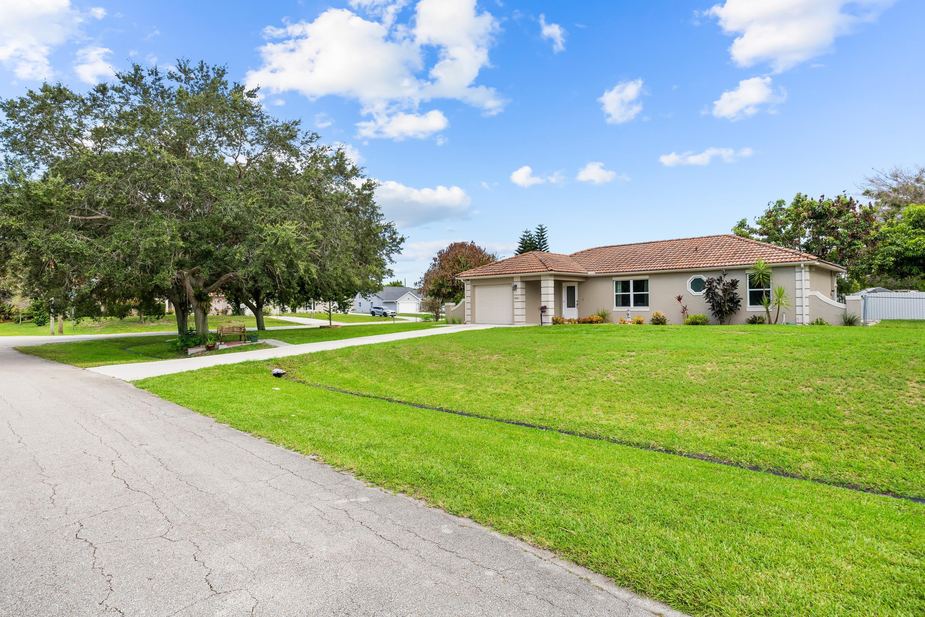 Beautifully updated and well-maintained 3-bedroom, 2-bath CBS home with a 1-car garage, ideally situated on an oversized corner lot in a desirable Port St. Lucie neighborhood. This home features all impact windows, tile flooring throughout, an updated kitchen with granite countertops and stainless steel appliances, and a desirable split-bedroom floor plan. Enjoy a spacious backyard with mature fruit trees, a paver sitting area and a covered gazebo, perfect for relaxing or entertaining. Conveniently located near I-95, the Florida Turnpike, shopping, dining, schools, parks, and everyday conveniences. No HOA. Don't miss this exceptional opportunity!