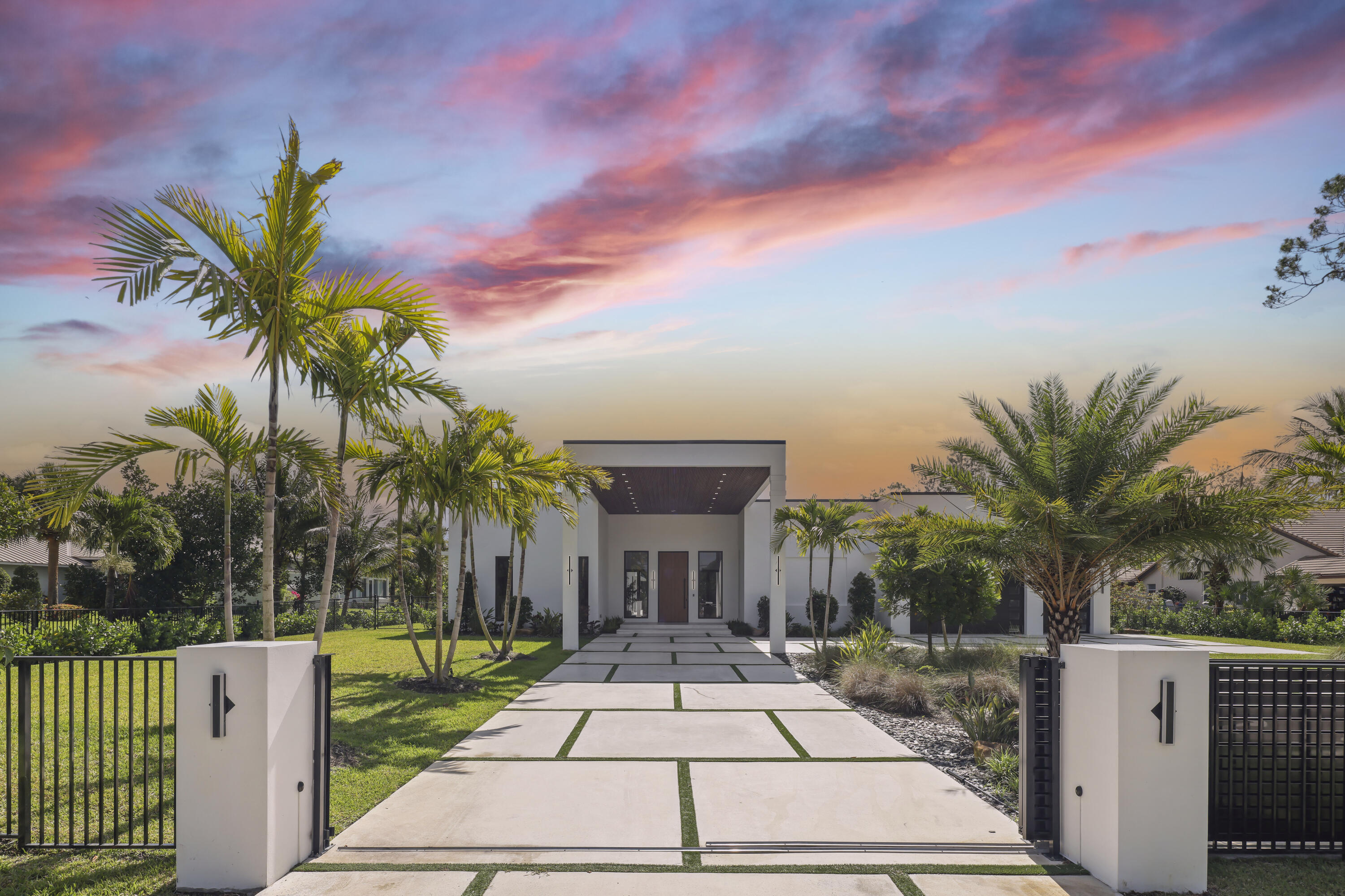 Seller Says Sell Now!! Massive Price Improvement on this brand-new stunning luxury spec home. Modern Luxury New Construction at its finest. This 7-bed, 8.5-bath estate spans nearly 7,000 sq. ft. with soaring 16' ceilings and sleek European cabinetry throughout. The chef's kitchen boasts Wolf appliances, an oversized island, Taj Mahal Quartzite countertops, and a built-in breakfast extension. Porcelain tile flows through the open-concept layout, seamlessly connecting a theater/media room, home gym, and private guest house. Additional features include a 500-gallon buried propane tank and accordion-style impact sliders that create effortless indoor/outdoor living. Enjoy resort-style amenities including two private pickleball courts, a full summer kitchen, and expansive outdoor lounge areas.