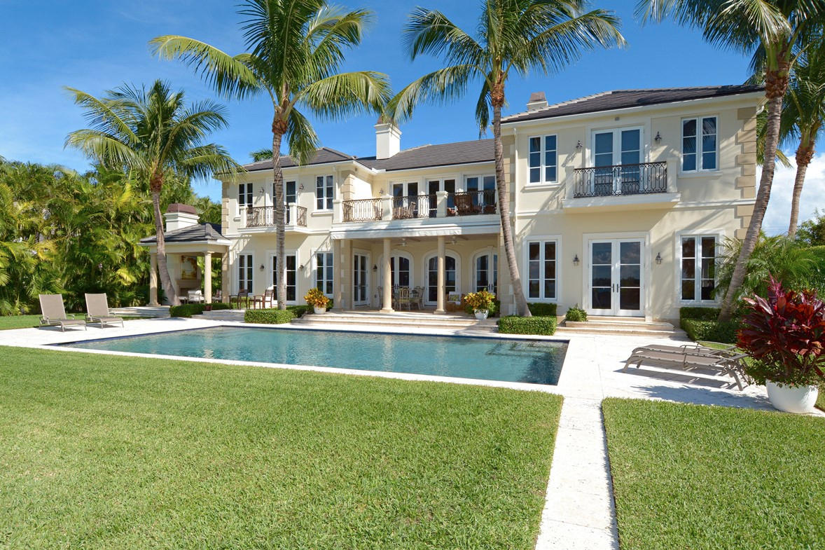 Better than new – custom built magnificent lakefront estate with stately front and rear elevation and expansive water views from virtually every room! Grand arrival through a hedged and manicured brick and pebble driveway into the expansive motor court, 3 car garage with staff, yacht captain or separate guest quarters (1 bed/1 bath) featuring a full kitchen and living area. Enter the main home and immediately breathtaking intracoastal views make the home bright and inviting from the living room, formal and informal dining, expansive family room – chefs kitchen, and library. Full master suite down & another upstairs! Elevator, gym or additional bedroom up – w/ ample additional guest bedrooms and a ''bonus'' air-conditioned third level for storage rarely seen in a Palm Beach estate residence Outdoors enjoy an oversize pool - privacy from all neighbors and a locked gate leads to your own private dock - wood and aluminum - a boaters dream! Interior finishes include stone and hardwood floors, exotic marbles and upgraded fittings. Pristine - nothing to do- condition. Over sized home site on one of the islands best locations. Generator, rare coquina stone patios, loggias and entry - entire property of the highest caliber and with extraordinary attention to every detail.