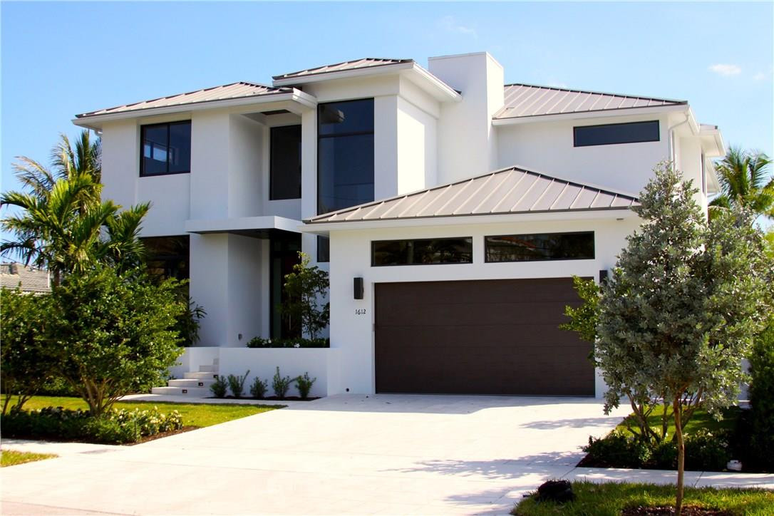 Just Completed! This Stunning Transitional Home located in the Rio Vista Isles is a must see! 5 Bedrooms 5 1/2 Bathrooms, Large open floor plan with premium finishes. Custom made cabinetry, vanities and fantastic large wood looking porcelain title throughout the home. Huge covered patio w/ outdoor kitchen, beautiful custom shell pavers in the backyard, pool has pebble finish and Infinity hot tub, 70Ft concrete dock, the house is wired for home automation, Elevator, 50 yr. Metal roof and Lush landscaping