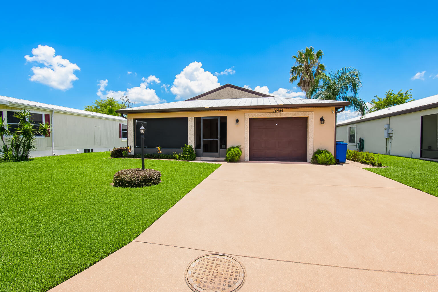 This gorgeous Waterfront, concrete block, single family home in Spanish Lakes Fairways offers smooth, waterfront living with double lake views. Enjoy serene water views from your screened front porch or glass-enclosed rear patio. Inside, the 2BR/2BA split layout features an open floor plan, beautiful floating laminate flooring, and plantation shutters. The open concept kitchen shines with granite countertops, stainless steel appliances, and premium cabinetry. This active 55+ community land lease covers premium amenities: free 18-hole golf, 2 heated pools, large clubhouse, pickleball, tennis, a fitness center, and lawn care. Located just minutes from I-95, this home offers easy access to historic downtown dining, shopping, and Treasure Coast Beaches. Don't miss out! Call listing agent now!