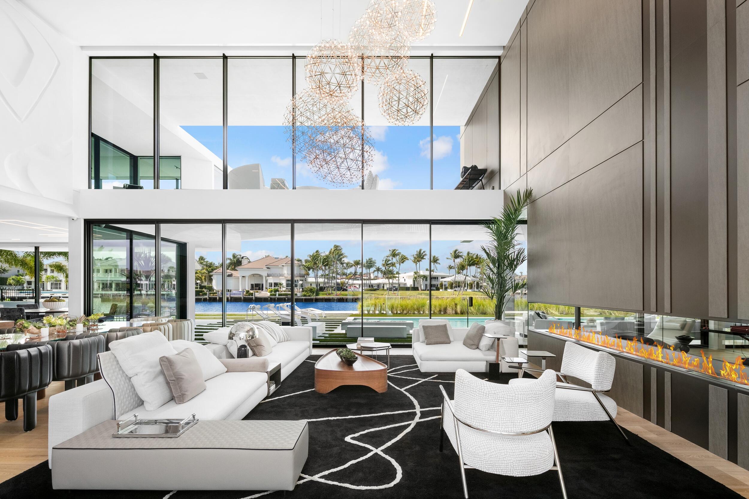 As seen on CNBC, transcend the expected at this award-winning new contemporary masterpiece brilliantly staged in Boca Raton's prestigious Estates. The trophy waterfront mansion, part of an exclusive enclave of luxury properties on a barrier island between the Intracoastal Waterway & the Atlantic Ocean, dazzles with architectural originality, exquisite craftsmanship & artful splendor. The architectural award-winning statement from Alex Penna, the Senior Designer & Principal of Studio KHORA. Bridges the worlds of light, space, texture & form to create an inspired visual experience unique to the luxury residential scene in south Palm Beach County. The epic two-story layout, encompasses nearly 10,000 square feet of living space with more than 15,000 square feet overall in a gated setting. Ideally situated along 125 linear feet of Intercoastal, the property basks in the comfort of unforgettable water views, and the glow of South Florida sunrises and sunsets. Innovative design and interiors are thoughtfully considered and combine contemporary aesthetic with form and functionality. The sprawling residence is grounded by solid commercial-grade construction that includes 155 concrete piles. Shimmering glass walls heighten the drama, creating an indoor/outdoor gateway to the scenic views and verdant landscape. Waterfalls, brise soleil features and exotic wood facade details add flair to the art of fine living. The sophisticated interior, expertly designed and furnished by Lesly Maxwell Interiors, boasts six bedrooms, eight full baths (including separate two primary baths), an office, a media room and a glass elevator. Dramatic lighting and double-height ceilings add to the grandeur of a first-floor living area that overlooks the water. European white oak flooring, bespoke cabinets by Neff, and state-of-the-art appliances incorporated into the design lend warmth and elegance to the spacious chef's kitchen. The seamless splendor extends to an elegant outdoor setting built for entertaining, with landscaping design by Greg Lombardi Design. Highlights include an impressive contemporary heated pool and spa, a lounge area, a full summer kitchen and a cabana bath. In addition, an oversized four-car garage can accommodate lifts to create space for eight cars and a golf cart. This residence sits at the nexus of Boca's most desirable destinations, just minutes away from the finest shopping, dining and social scenes--including the famed Boca Raton, the legendary luxury resort and beach club. Experience 2633 Spanish River, a privileged place to call home.