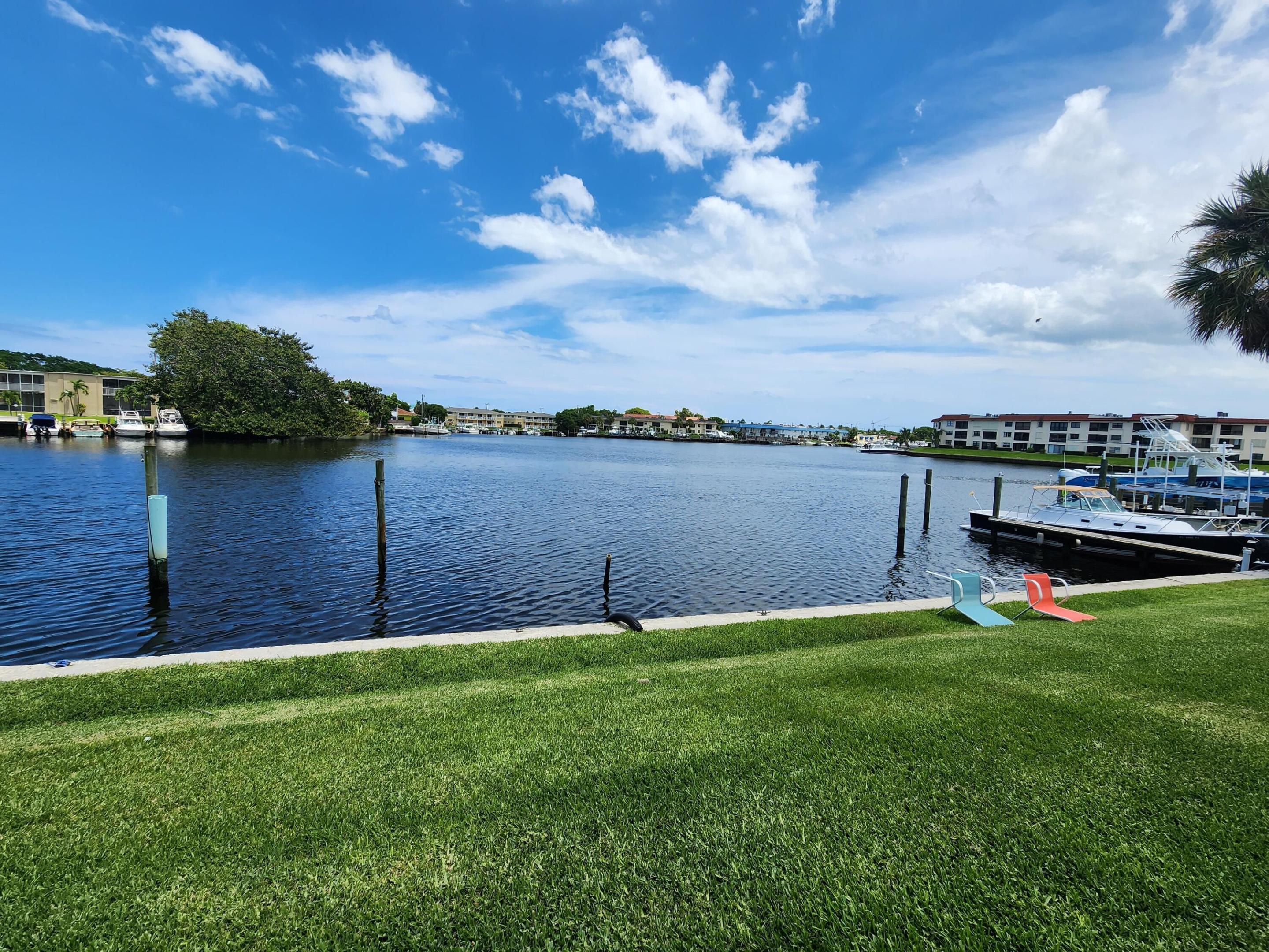 Waterfront living in the heart of North Palm Beach! This beautifully renovated 2-bedroom, 2-bath second-floor apartment is located in a charming six-unit building overlooking the Earman River. Enjoy peaceful water views from the screened patio and spacious living area. Slider and windows are impact.  Recent updates include a modern kitchen with white shaker cabinets, quartz countertops, stainless steel appliances, renovated bathrooms, luxury vinyl plank flooring throughout, and stackable washer and dryer in the unit. Light and bright with an open layout, this move-in-ready residence offers convenient access to beaches, marinas, golf, shopping, dining, and major highways. Don't miss this opportunity to enjoy the South Florida waterfront lifestyle.