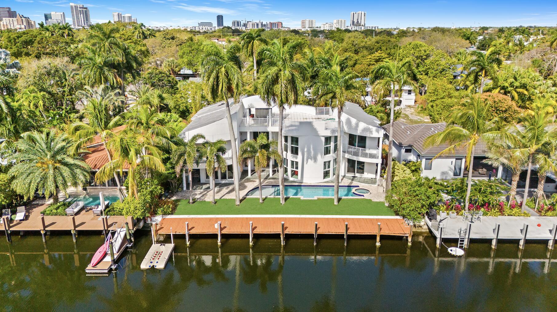 Stunning contemporary waterfront estate on the Karen Canal in prestigious Victoria Park, offered fully furnished. Privately gated on a quiet dead-end street, this luxury residence features soaring ceilings, expansive living spaces, impact windows and doors, and designer finishes throughout. Gourmet chef's kitchen with custom cabinetry, oversized island, and premium appliances. Flexible floor plan with a first-floor guest suite, gym/fifth bedroom, loft, and spacious ensuite bedrooms. The primary retreat offers four walk-in closets, a sitting area, spa bath with Roman tub and steam shower, and private balcony. Rooftop deck, multiple outdoor entertaining spaces, 2-car garage, private dock with ocean access and no fixed bridges. Minutes to Las Olas, the beach, and Galleria Mall.