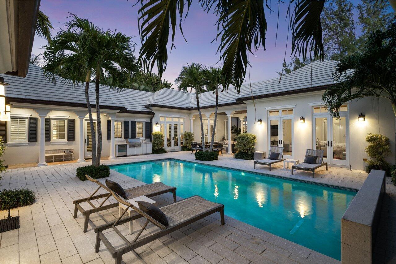 Located in the heart of Gulf Stream, 3424 N Ocean Blvd is a meticulously maintained Bermuda-style estate offering private beach access just steps away. This architectural gem spans 5,875 square feet, featuring a 4-bedroom, 4.5-bath main residence and a separate guest house with an additional bedroom and bath. Designed for effortless luxury, the home showcases vaulted tongue-and-groove wood ceilings, impact windows and doors, marble and hardwood flooring, and custom moldings. The gourmet kitchen, outfitted with top-tier appliances and a spacious island, flows seamlessly into the sunlit gathering room. The primary suite, complete with a sitting area, opens via French doors to the pool, offering a tranquil escape. Outside, an expansive loggia centered a cozy fireplace, summer kitchen, and waterfall pool combine to create a private oasis, surrounded by lush landscaping. Ideally located near GSS, Atlantic Avenue, Worth Avenue, and Delray Beach, this estate blends seclusion and convenience, making it a rare Gulf Stream opportunity. The best part of going out is coming home to this serene retreatyour private sanctuary by the sea.
