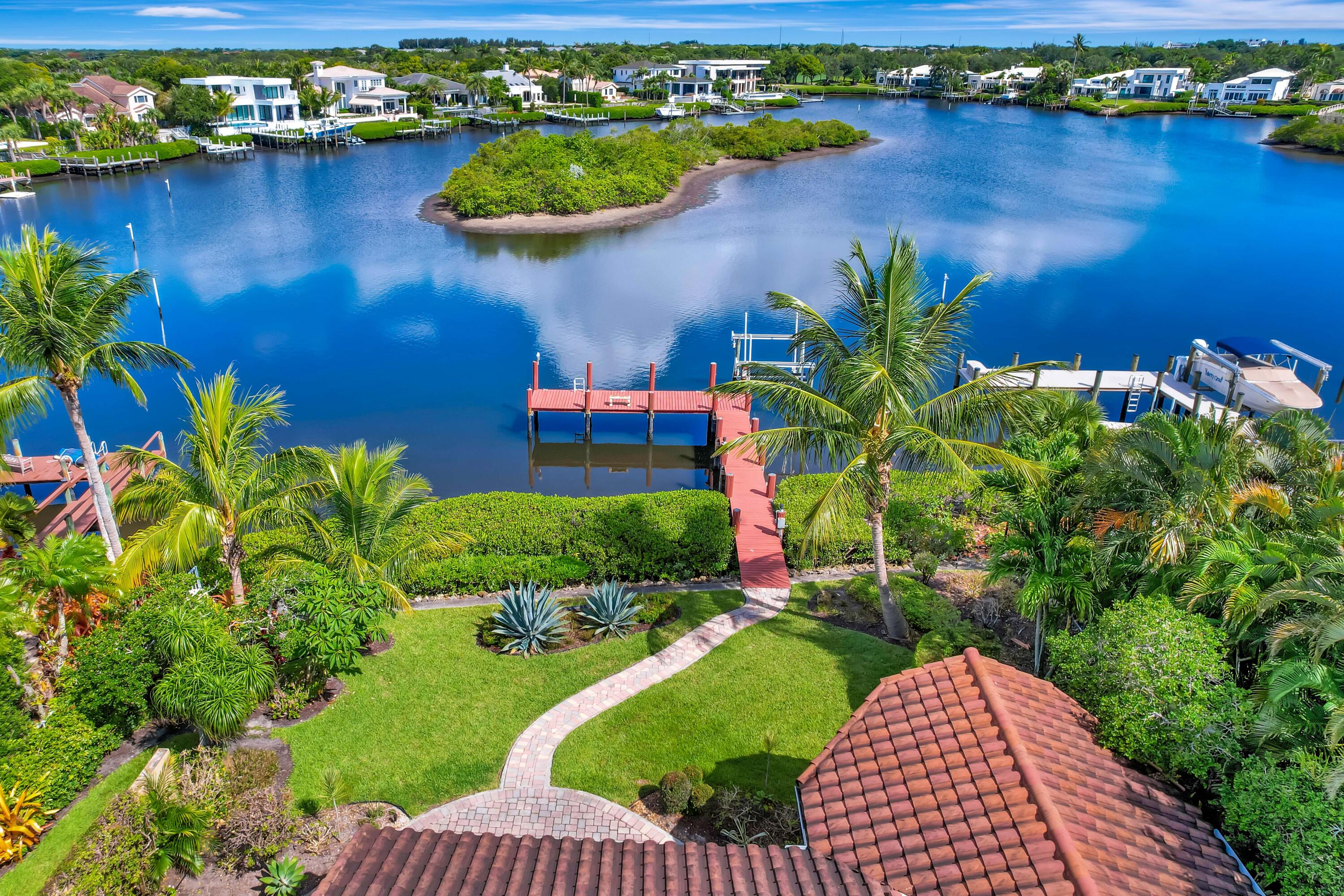 A rare opportunity to acquire a premier waterfront homesite on one of Admirals Cove's most desirable cul-de-sac streets, this property captures one of the community's most spectacular wide-water panoramic vistas while offering exceptional privacy and no through traffic. The setting is truly difficult to duplicate, especially at this price point. Comparable newly completed homes on this street are valued in the $12-$13 million range, making this an exceptional opportunity for an end user or builder seeking a premier luxury location with strong long-term value. The property features a private dock capable of accommodating a vessel up to 50 feet, providing direct access to the Intracoastal Waterway and the ultimate South Florida waterfront lifestyle. Ideally situated just minutes from the... front entrance, residents enjoy convenient access to Admirals Cove's renowned collection of world-class amenities, including two spectacular clubhouses, 45 holes of championship golf, five restaurants, a 58-slip marina with floating docks, a Yacht Club, nine Har-Tru tennis courts, 12 pickleball courts, a state-of-the-art fitness and wellness center featuring Technogym equipment, a 21,000-square-foot spa and salon, the 30-room Waterside Private Boutique Hotel for members and their guests, a new Golf Learning Center, Covesters Kids Club, a dog park, and the exceptional Platinum service that defines the Admirals Cove lifestyle.