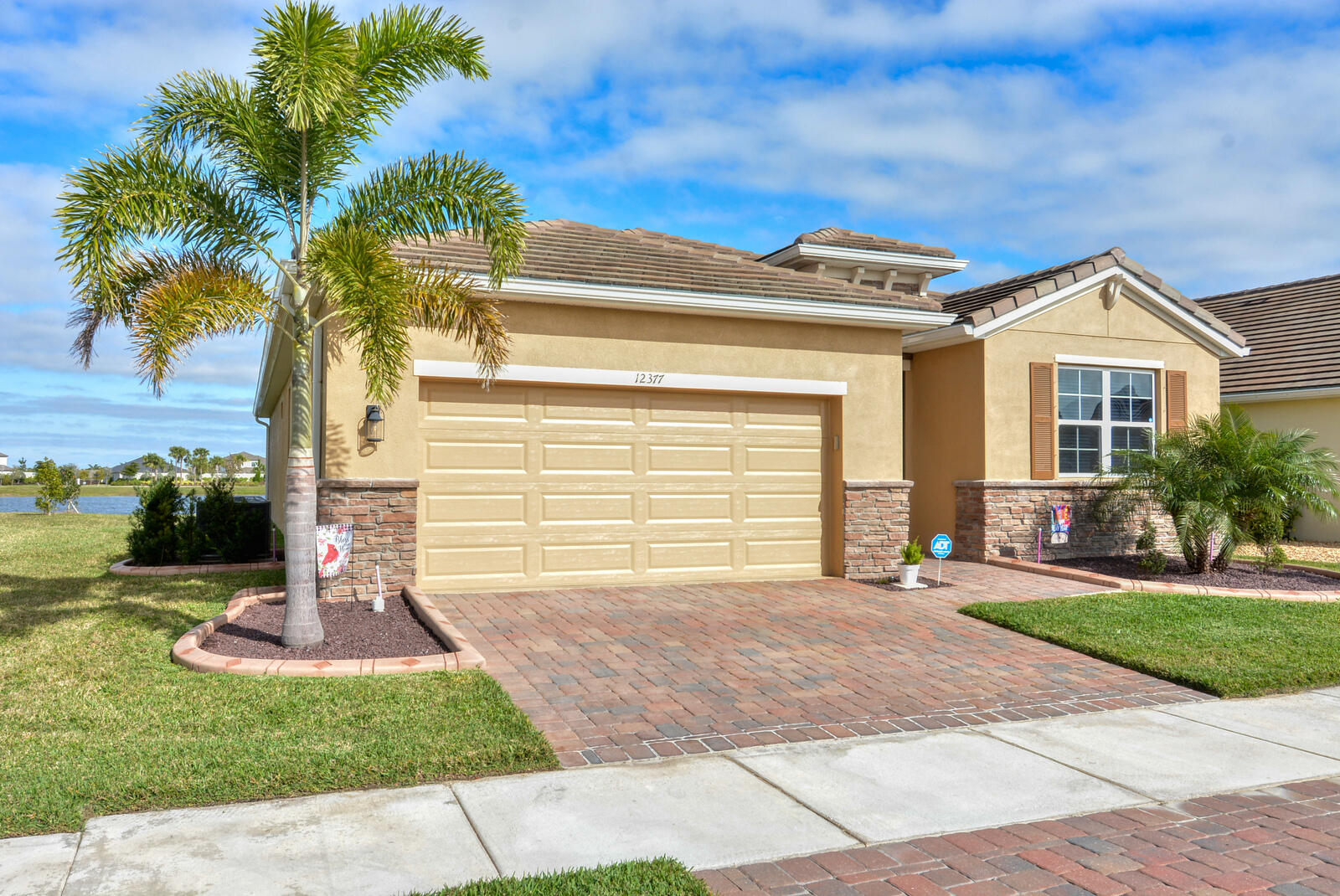 Welcome Home to this amazing eco-friendly / energy efficient smart home located in the gated and secure private community of The Preserves / Estates of Tradition.  This pristine 4BD, 2BA, 2-car garage single family home, situated on the lake, provides stunning sunrise views as well as picturesque sightings of jumping fish and water fowl from the expansive back patio where tranquil tropical breezes abound.  The open floor plan is accentuated by the exquisite white granite kitchen counter tops with Breakfast Bar; ceramic tile throughout the main living areas; SS appliances; ceiling fans and decorative lighting.  The Owners suite boasts dual vanities, large wall mirror, walk in shower and water closet.  Additional upgrades have been added and include New state of the art ADT alarm system with two monitored smoke alarms; New Epoxy flooring in the garage and the back porch;  painting of the exterior and much of the interior as well as a number of palm trees and 4 decorative splash outs with additional plants and stone to enhance the plush front landscaping creating a true turn-key residence.  Come and enjoy the many events offered at Tradition Square throughout the year as well as easy access to restaurants, medical care and shopping - all just minutes away from your front door.  Private showings by appointment only.
