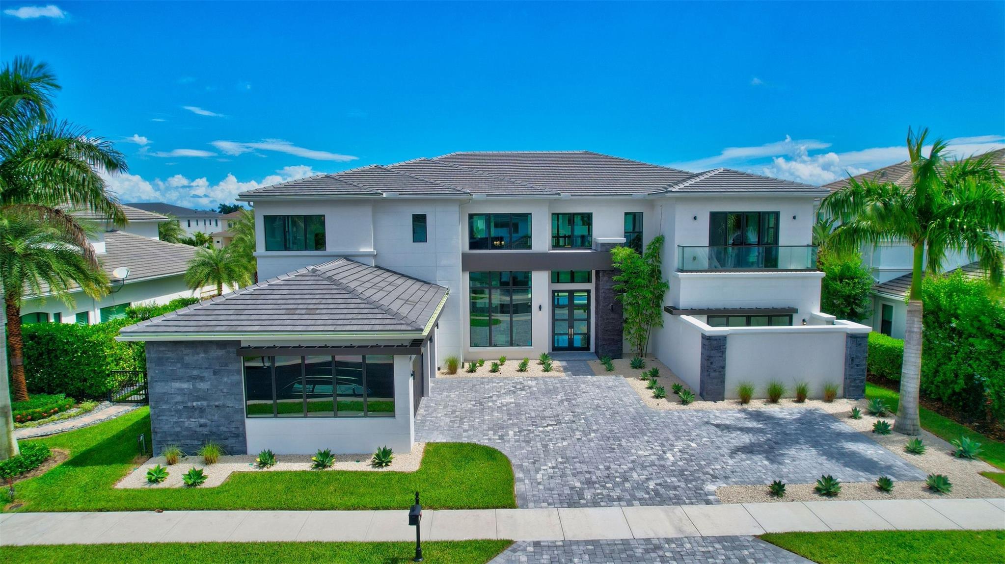 Welcome to your dream home! Step into this magnificent home, you'll immediately be greeted by the soaring 23' ceilings & an abundance of natural light. Enjoy the temperature-controlled wine room w/ a well-appointed wet bar. The custom kitchen features top-of-the-line Wolf & Subzero appliances, 2 walk-in pantries, 2 dishwashers & natural gas. 2 primary bedrooms & 2 laundry rooms. Step through the 10" sliders in the family room to access the outdoor paradise, which features a generously-sized covered patio, a heated pool with 2 sun shelves, & an outdoor shower—all overlooking the tranquil lake. Royal Palm Polo is an exclusive gated community located centrally in Boca Raton. Residents of Royal Palm Polo enjoy a range of amenities.