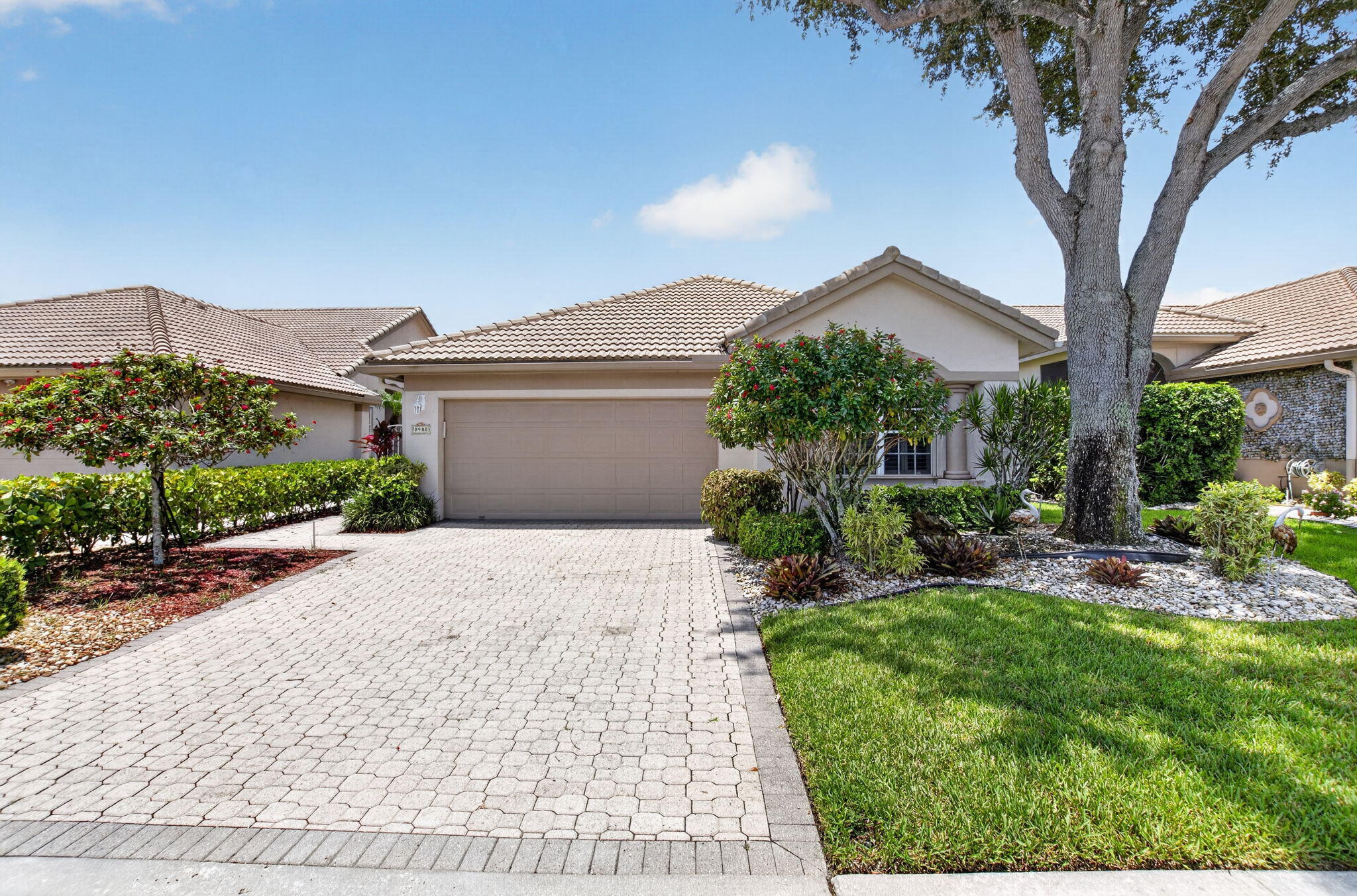 Rarely available, exceptionally clean, and spacious townhouse in the prestigious, manned-gated Lancaster Lakes of Aberdeen Country Club! From the private courtyard, enter a bright, open floor plan with high ceilings and elegant plantation shutters. The kitchen features sleek granite countertops, a full backsplash, and stainless steel appliances. The oversized primary suite includes an updated bath with dual sinks. The 2nd bedroom features custom built-ins including a murphy bed, easily converting the space from an office to a guest bedroom. Enjoy the screened-in, air-conditioned lanai overlooking a peaceful backyard. Additional features include a 1-year-old AC, accordion storm shutters, a 2-car garage, and a 2008 roof.