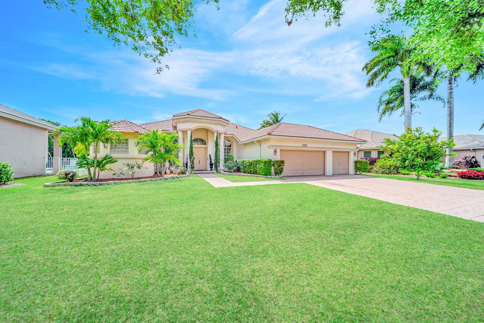 Offered exclusively in the prestigious "Chateau" Estate section of Coral Springs' gated Grand Reserve community, this stunning 5-bedroom, 3-bathroom, 3-car garage home sits on an oversized 11,620-square-foot lot that backs directly to a serene nature preserve with no rear neighbors. The one-story Monterey model features a triple split bedroom layout for optimal privacy, soaring 12-foot volume ceilings, custom crown molding, rounded corners, and abundant natural light throughout. The open design includes formal living and dining rooms, a spacious family room, and aMODEL floor plan with a large formal living room and dining room, an enormous family room adjacent to the upgraded kitchen. Large kitchen features granite counter tops, stainless appliances, upgraded bay windows, a center island,  bay windows, and extensive cabinetry. Tile flooring flows through the main living areas, while laminate wood flooring warms the bedrooms. The expansive master suite offers two large walk-in closets, sliding doors to the pool, and a luxurious en-suite with dual vanities, a walk-through shower, and a Roman tub. The tropical backyard features a covered patio, pavered entertainment area, and a large pool with waterfalls and a sun shelf beach area, all surrounded by lush landscaping and exotic fruit trees including sugar apple, Jamaican blue coconut, Hawaiian papaya, Thai banana, sapodilla, red dragon fruit, soursop, rose apple, and Thai mango. Additional highlights include a fully fenced yard, a 3-car garage, a paver driveway accommodating six additional vehicles, dual-zone A/C units and a hot water heater both less than two years old, and an indoor laundry room. Grand Reserve offers 24/7 manned gated entry and security patrol, plus a clubhouse with fitness center, billiard room, heated adult and children's pools, and a tot lot playground—all within walking distance. The home is ideally located near Park Springs Elementary, Forest Glen Middle, and Coral Springs High School, with quick access to the Sawgrass Expressway and Florida Turnpike, and less than a mile from Walmart, Target, Publix, Home Depot, and numerous dining options. This beautifully maintained home is being sold in its present physical condition, and the purchase contract will be an "AS IS" contract, with seller making no repairs or improvements.