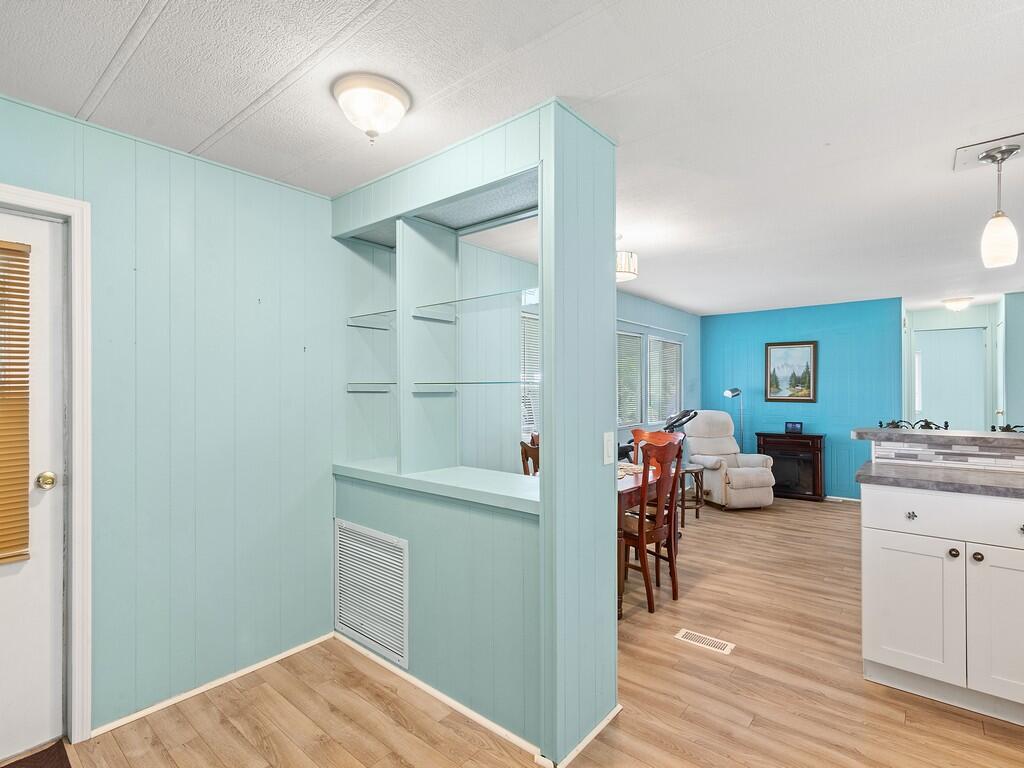 This 2/2 mobile home located in the 55+ community of Pinelake Village in Jensen Beach has a cute beachy vibe that makes for a great getaway or a perfect retirement home.  The kitchen and bathrooms have been totally remodeled and it has a new A/C unit and new washer and dryer, new flooring throughout, and a large screened in patio.   The roof has a lifetime warranty, vapor barriers to keep your crawl space dry are intact and it also has double tie-downs.  Lot rent is only $805 per month and includes cable, trash removal, recycling and all the amenities of the clubhouse.  Conveniently located close to downtown Jensen Beach for shopping, dining, and the beaches.