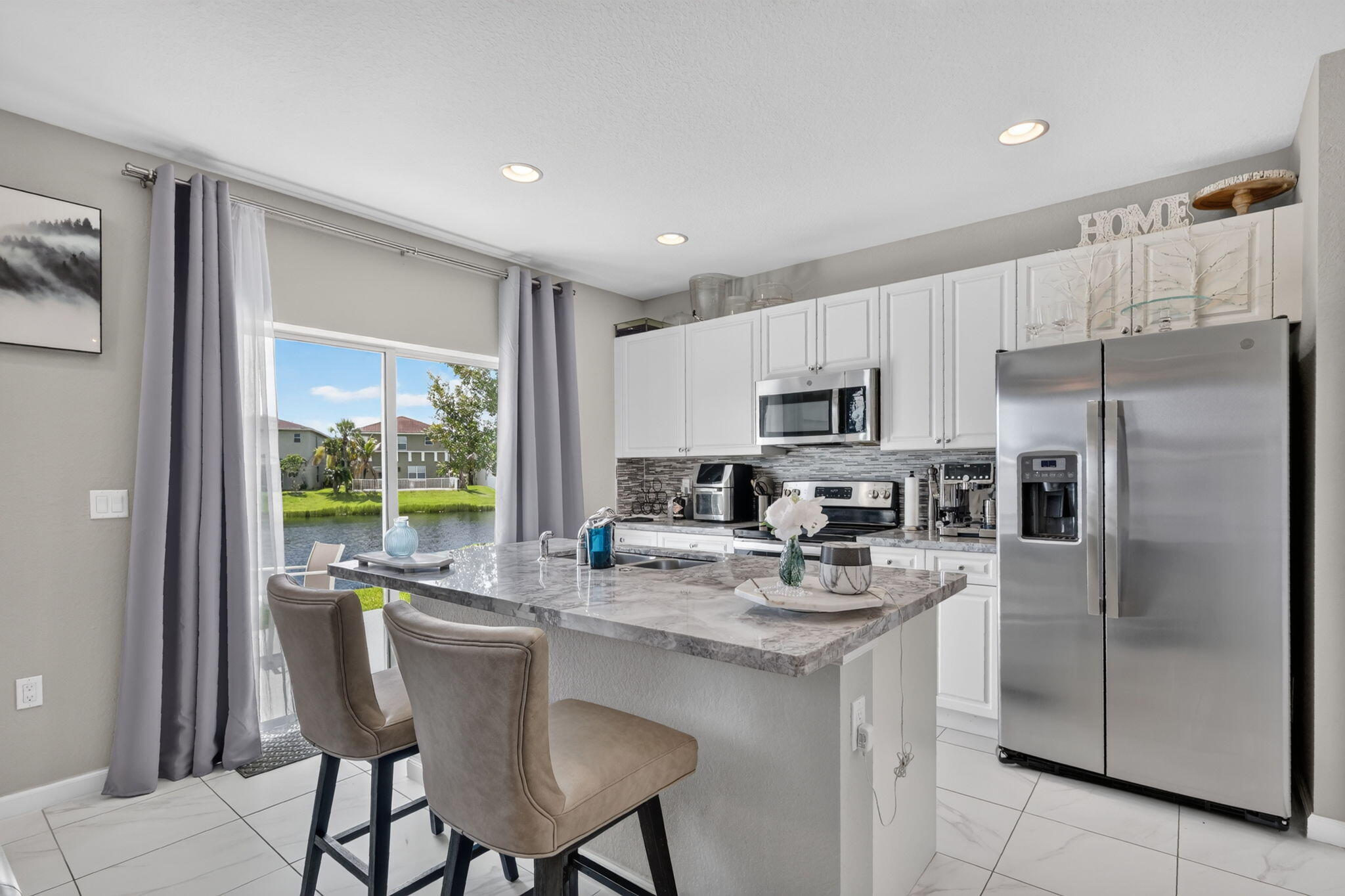 Vizcaya Falls in Torino offers wonderful amenities at a lakefront clubhouse with a resort style pool, fitness center, volleyball, tennis, basketball, community room, game room, playground with slash area and gas grill for pool party picnics.  Beautiful lake view end unit townhome with 3 bedrooms and 2 1/2 baths and large 1 car garage with electric car plug in.  Gorgeous white kitchen cabinets, large pantry,  granite counter tops with tiled flooring on main level. Master bedroom with lake view, large walk in closet, dual vanities and walk in shower. Minutes to I-95 and the Atlantic Ocean, beaches, parks, inlet, shopping and Mets stadium.  Monthly fee includes all amenities, lawn care, roof maintenance, internet, security monitoring,   Call today for your private tour.