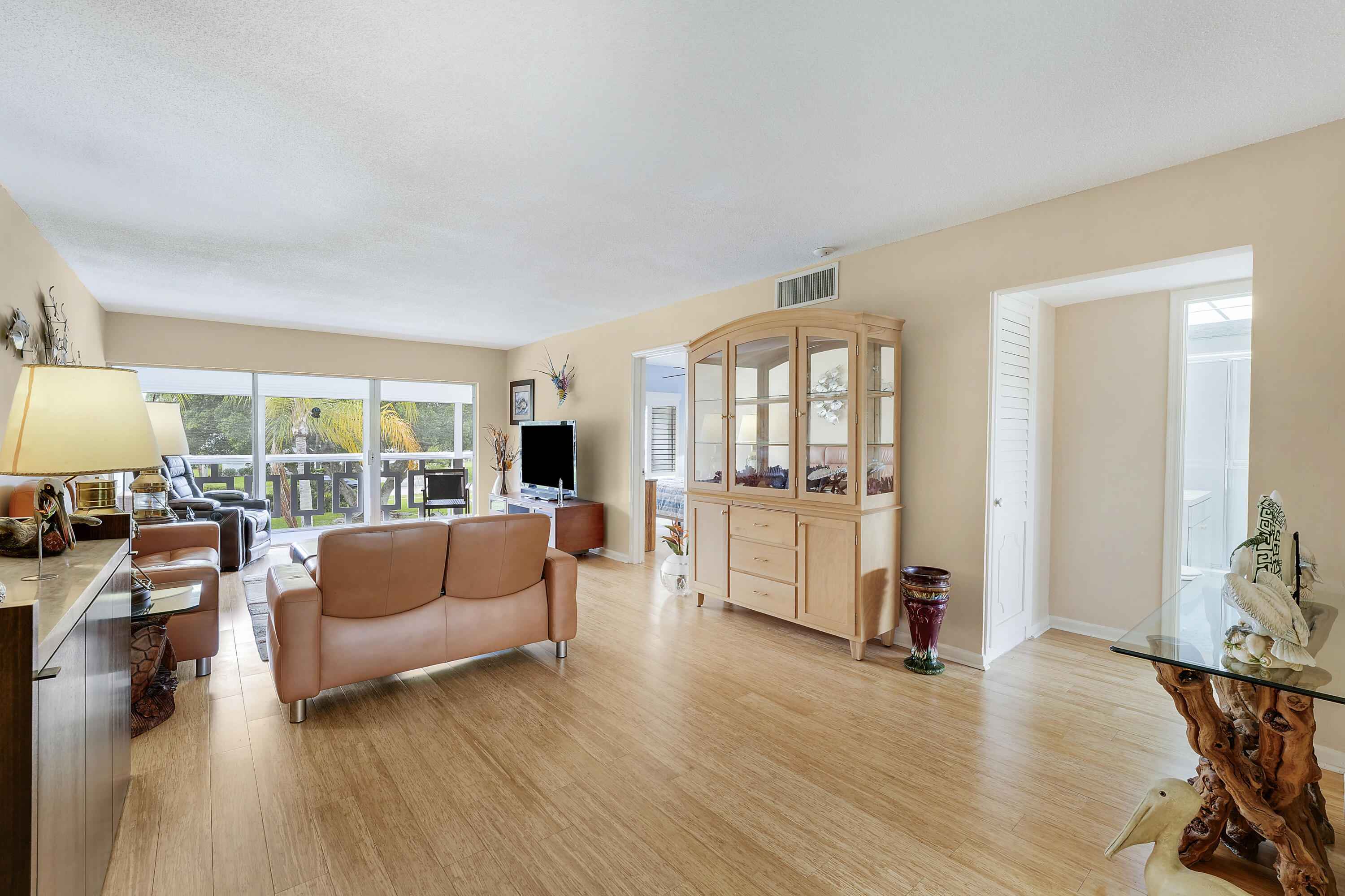 Very  clean condo in the Village of Tequesta.   Convenient to all Tequesta has to offer, shopping, restaurants and beaches.  Nicely furnished living area and prime bedroom which has a king sized Sleep Number bed.  Second bedroom could be furnished as a bedroom or used as an office or hobby space. Wood flooring throughout living area and bedrooms, plenty of closets.  The HVAC was replaced in 2025. Nice screened patio with rolldown shutters overlooking the common area. Ready for a new owner.  Unit can also be sold unfurnished.  Don't miss out on  this one.