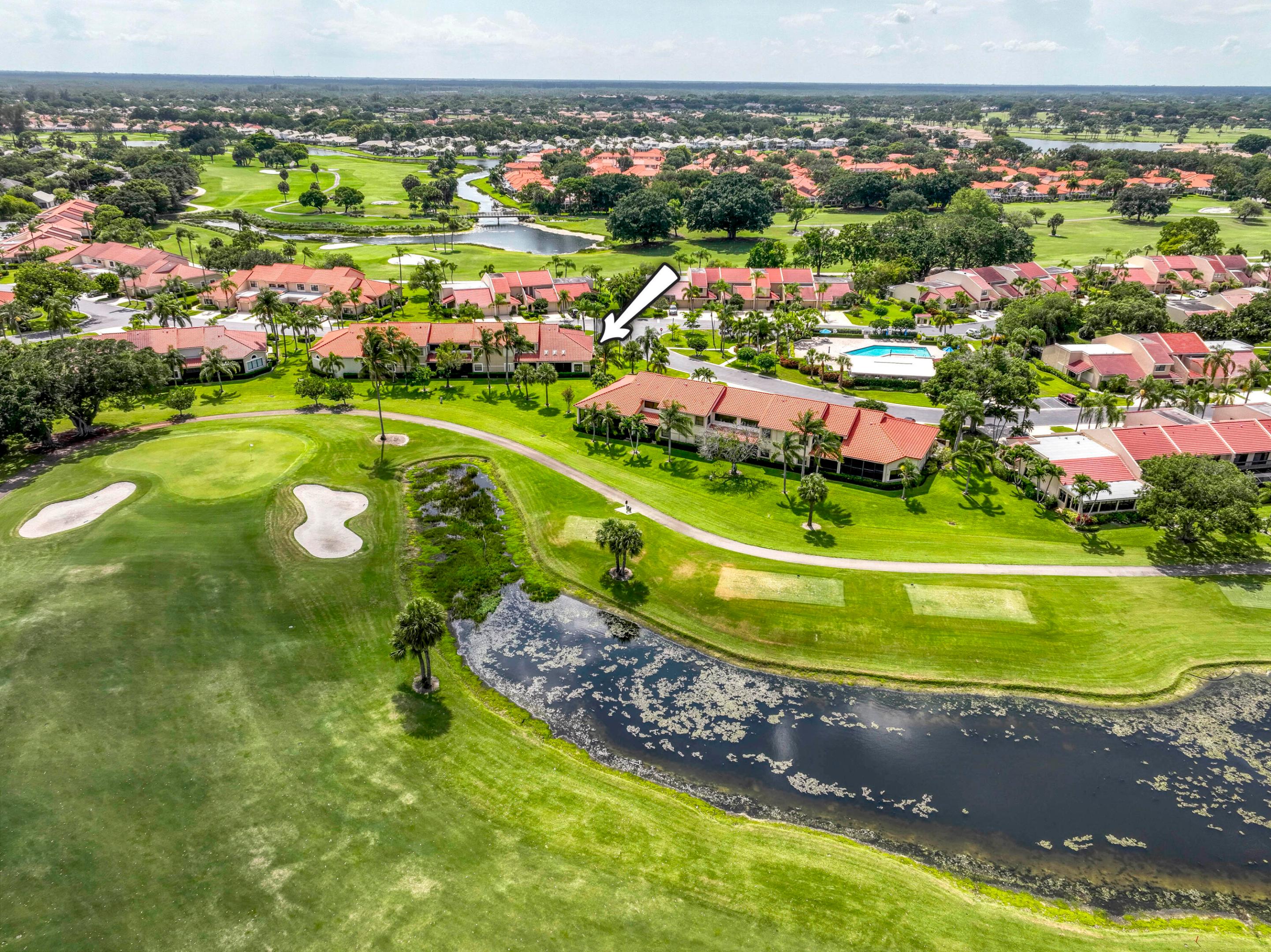 Enjoy golf and lake views from this beautifully situated corner villa in Windermere at PGA National. Offering 3 bedrooms, 2 bathrooms, a 1-car garage, and approximately 1,600 square feet under air, this one-story residence features a desirable split-bedroom floor plan and an open-concept layout designed for comfortable living. The living and dining areas flow seamlessly together, creating an inviting space for everyday living and entertaining. The kitchen is appointed with cream cabinetry, granite countertops, stainless-steel appliances, and a cozy breakfast area. Just off the entry, a flexible room provides the perfect space for a home office, den, or reading room. The primary suite features two closets and an en-suite bath. Sliding glass doors from the kitchen, dining area, and primary  bedroom open to a screened lanai overlooking the Palmer golf course and lake, creating a tranquil setting to relax and unwind.