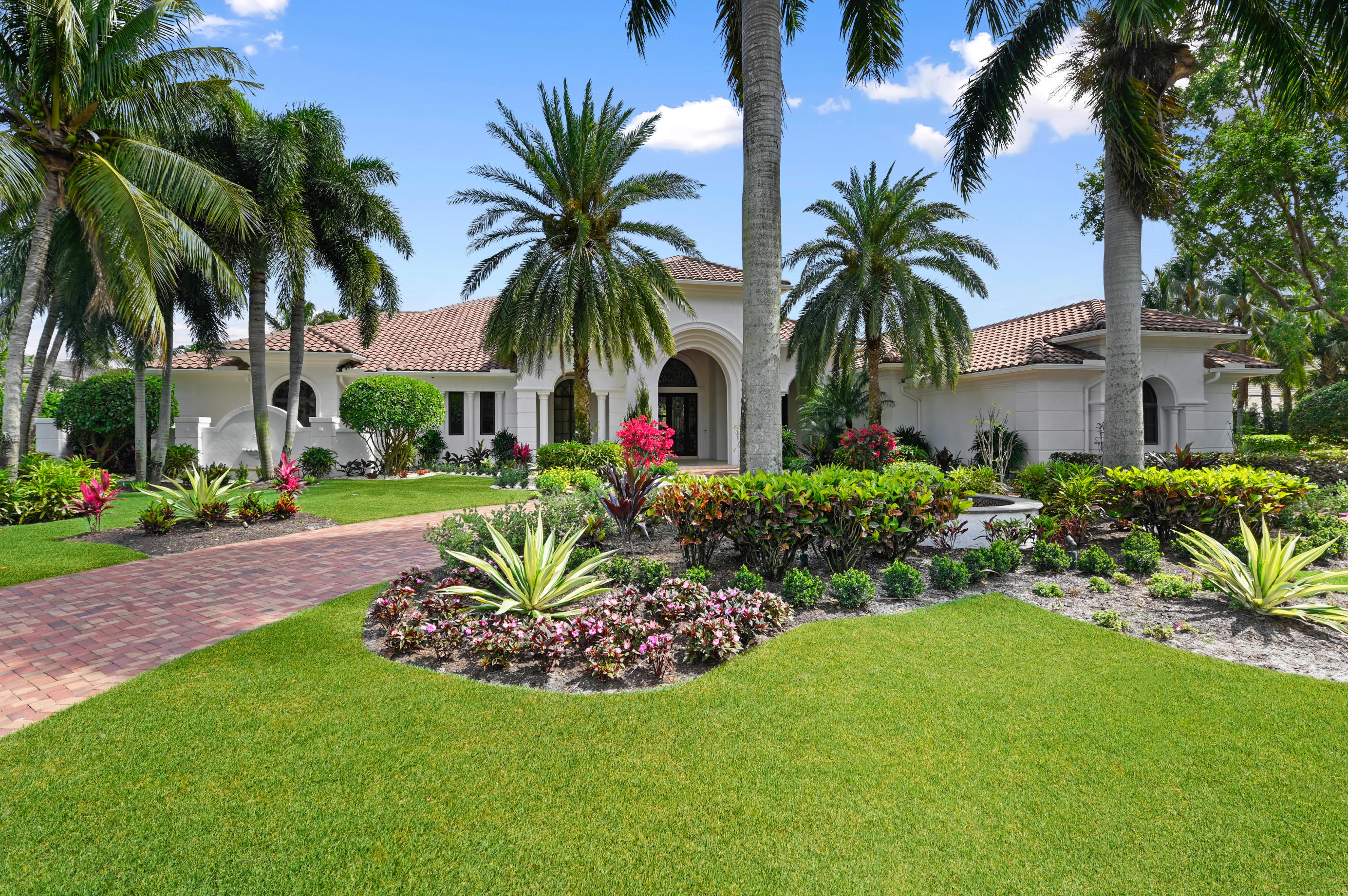 This magnificent, recently renovated 8, 234 sq. ft of living space home is not to be missed. Located on a very private acre lot with the best views of the lake and the fairway of the Par 5, 12th hole at Old Palm. Freshly painted inside and out, complete hurricane impact windows and doors and full house generator. This master bath has been fully reimagined with His/Hers separate baths and closets and gorgeous new countertops finished in a beautiful white/blue quartzite. New flooring throughout the home in a light ceramic tile. Kitchen has gorgeous custom cabinetry with calcite and quartzite countertops and eye catching cobalt blue island. The Butler's Pantry is finished in the same cobalt blue and is simply spectacular. Large formal and informal gathering areas including club room and spectacular home theatre leave plenty of space to gather with friends and entertain. 4 ensuite bathrooms, laundry/ pantry complete this home. 5 car garage plus golf cart off of driveway with large circular driveway in front of home - perfect for guest parking. This is one of the best offerings available in Old Palm today!