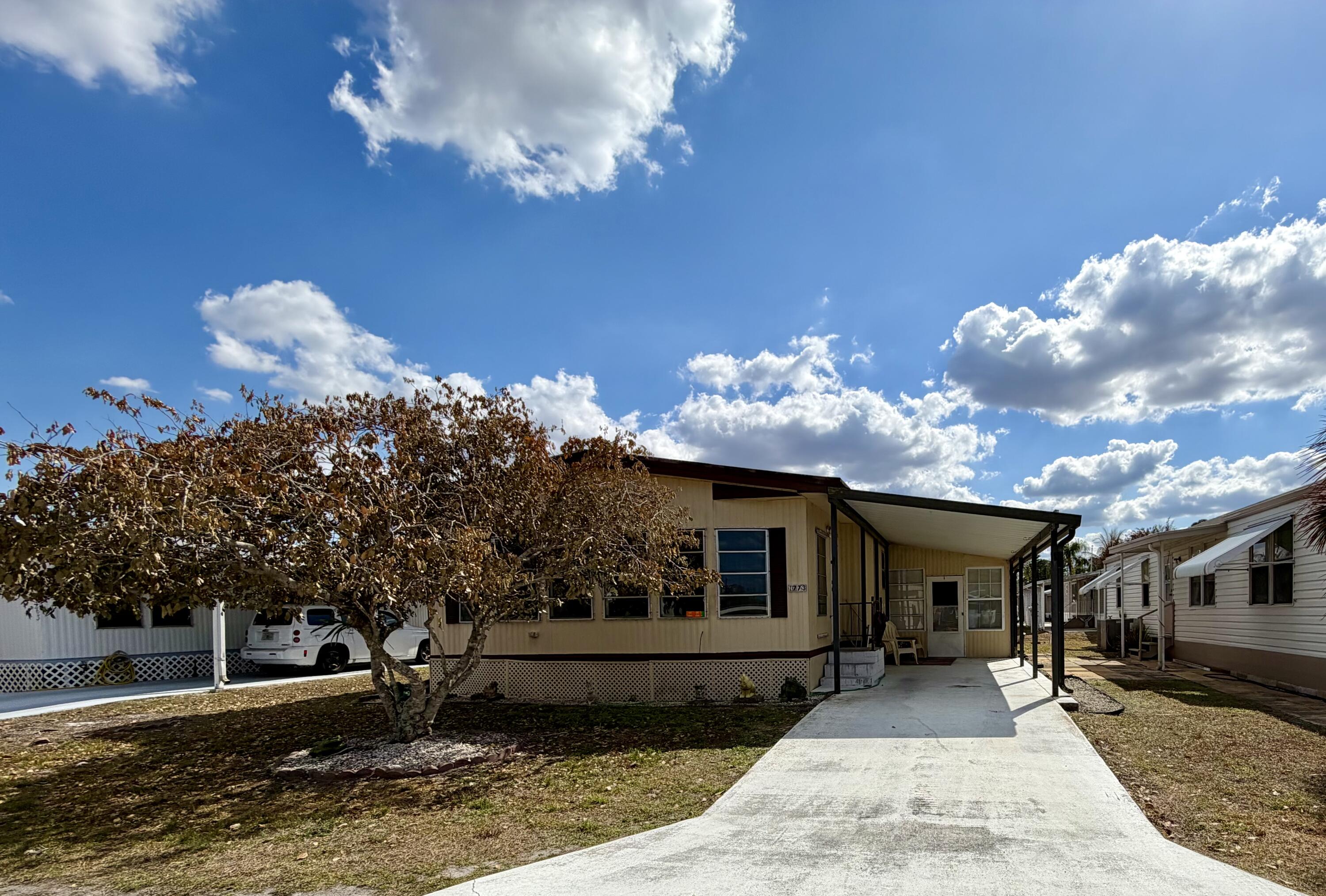 Bring your paintbrush, muscles and imagination.  Make this home your own in this nicely maintained community in Stuart.  Royal Palm is a 55 plus community. Lot lease of $900 covers taxes, lawn care and amenities.  Future residents must be approved by Management.  Please call for application.