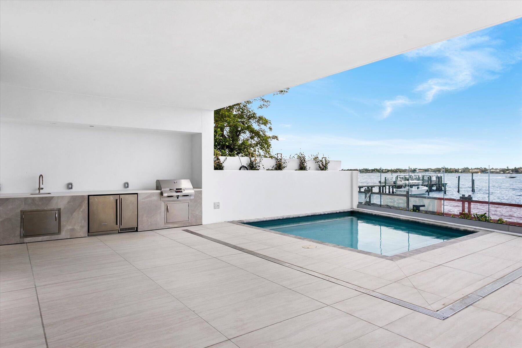 The ONLY DIRECT WATERFRONT Intracoastal Townhouse available in West Palm Beach! Brand new and never lived in.  4 Bedrooms, 4-1/2 baths with a huge waterfront patio with a private pool and outdoor kitchen, as well as a second floor waterfront balcony, all directly overlooking the intracoastal.  The amazing amenities in this 52 unit condominium include a concierge, valet, theater, club room, billiard room, both East and West facing pools with cabanas, fitness center, massage rooms, bike storage, cafe, wine lockers, private dining rooms, multiple entertaining spaces, community dock (coming soon) and garage parking. Call Guy or Geri for a private showing