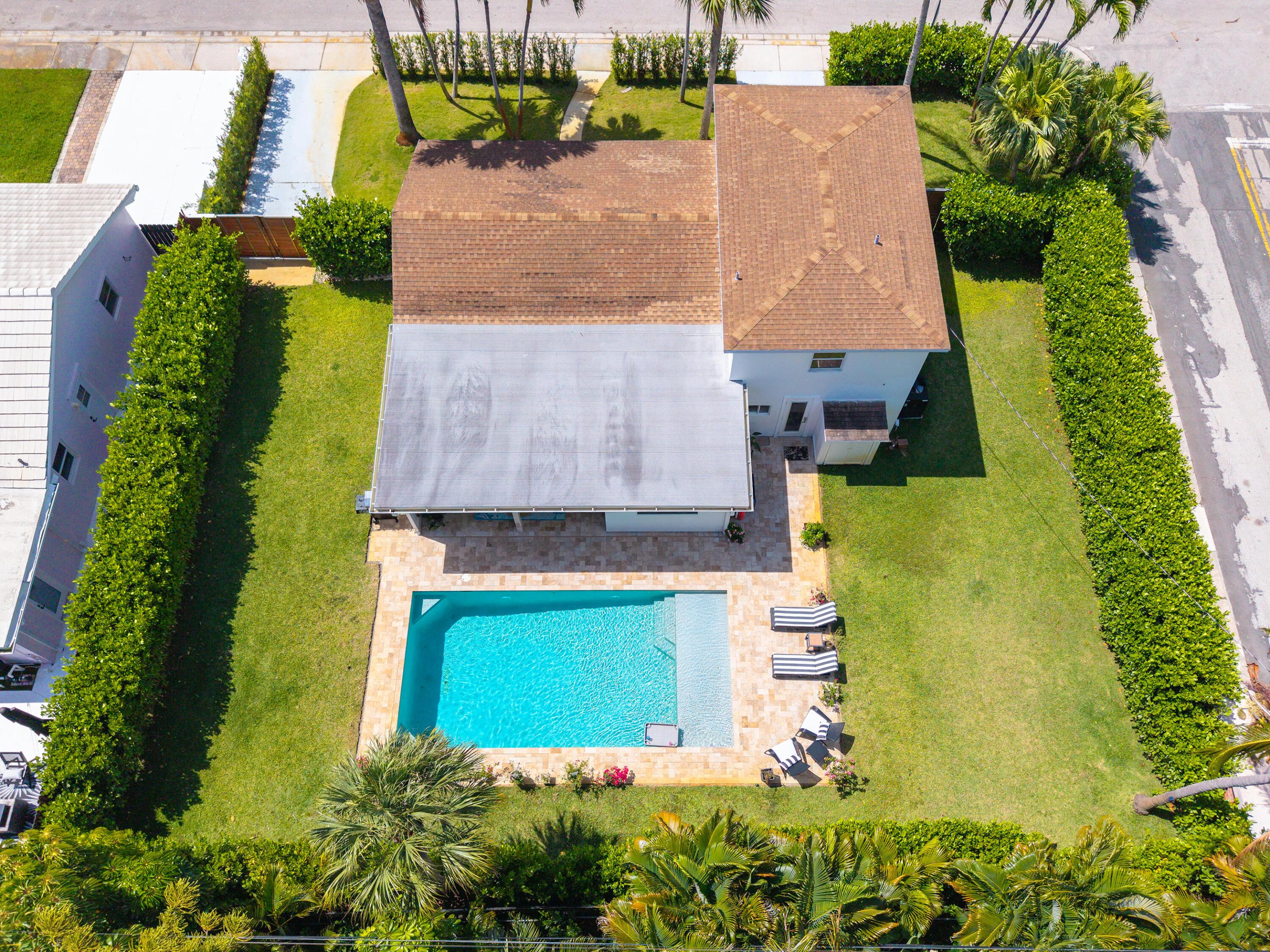 Exquisitely reimagined mid-century modern residence in the coveted South Palm Park district of Lake Worth Beach. Situated on a rare double corner lot, this 3-bedroom, 2 bath home showcases refined design with a chef's kitchen featuring Bosch appliances and quartz surfaces, and luminous open living spaces. The private, hedged grounds reveals a resort-style saltwater pool and travertine patio—an exceptional retreat just moments from downtown and the ocean. Expansion plans are in place and approved by the historic board to enlarge the home on this beautiful 10,000 sq/ft lot. Bring your boat, the side yard will accommodate to 45 feet. No detail has been missed on the beautiful residence that awaits you and your dreams.