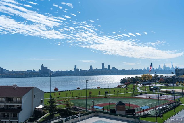 Very rare, very sought-after Southeast Corner Unit is ready to be Your New Home! Stunning Views of The Manhattan Skyline, Hudson River and George Washington Bridge will elevate your everyday experience! Hardwood Flooring throughout, Updated Kitchen with Quartz Counters and Tons of Natural Light gleaming in! Custom Window Blinds and Closet Systems make this a true move-in ready home! Very large, 40sf, wrap-around balcony with option to install screens and windows. Monthly Maintenance includes ALL UTILITIES: Electric, Heating, Cooling, Hot & Cold Water, Cable, Internet and also Two Parking Spaces. Building Amenities include 24hr Concierge, Pool, Tennis Court and Gym. Conveniently located within walking distance to NY Waterway Ferry, NY Bus Stop, Veterans Park, Restaurants, Shops, etc. Watch the video for full tour and layout!