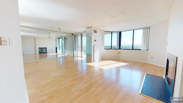Stunning, Oversized & Rare condo offers 2 Bdrms/ 2 Full Baths w/ Oversized Eat-in Kitchen, w/ spectacular views of NYC Skyline from the walk-out Terrace. Located on the 16th Floor, only steps from the Elevator, this corner unit has 1641 sq ft of living space, features a Large Entry Foyer, Formal Dining room w/ Balcony, Living room, Eat-in Kitchen w/ Stainless Steel appliances. Laminate Floors throughout! Master bedroom suite w/ walk-in closet, oversized master bathroom w/ Jacuzzi, Stall shower & double sinks. 2nd Bdrm & 2nd baths in the hallway. Central A/C, washer/dryer in-unit, 1 Indoor prkng space deeded w/ the property. Harmon Cove Towers is a beautiful complex w/ many amenities incl 24 hr doorman/concierge, security, elevators, pool/kid's pool, gym, steam room, basketball/tennis courts, kid's play room, game room, play area etc. Easy NYC commute, Express NJ transit bus stops right under the bldg, ideal location in close proximity to NJ Trnpk, Rt 3, Rt 1-9 & Newark Airport