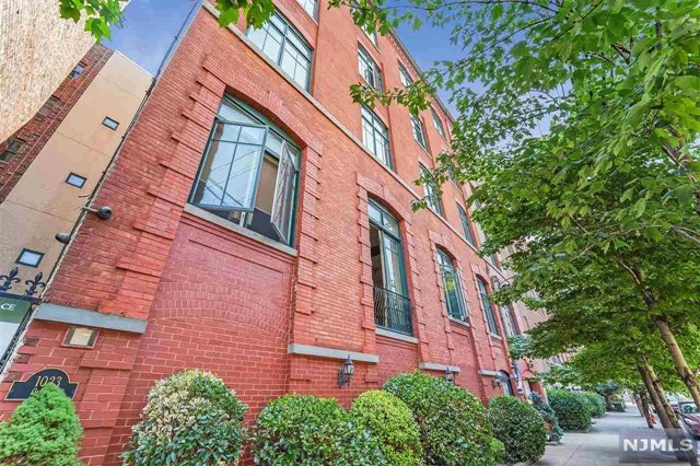 Extraordinary True Loft living with nothing left to do but turn the key and move in. Enjoy the spacious open feel as you enter your 2 bedroom, 2 bath home with soaring 12 ft ceilings throughout. The large open kitchen features granite countertops, stainless steel appliances and breakfast bar. Complete with hardwood floors throughout, exposed ductwork, overhead lighting, a new in-unit washer/dryer, New central AC system and hot water heater, spacious closets and two upgraded baths with tumbled marble tiles. Your converted factory loft style building features a new roof, an elevator, a deeded storage unit in the garage and a beautiful common brick lined backyard that is the perfect spot for barbecuing, entertaining or relaxing after a long day. Situated on a sought after uptown tree-lined street just a half a block from Columbus Park and Transportation to NYC right outside your door, easy access to Trader Joes and all that Hoboken has to offer.