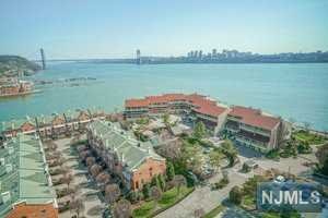 Rare, spectacular NYC views from every room! All utilities including gas, electric, water, cable included in rent. Sunny and spacious living room opens to dining room with wall to wall windows overlooking amazing views of Hudson River and GW Bridge. You will not want to leave your 40 sf wrap around enclosed terrace with these breathtaking views. Terrace with new face lift & railings. Updated galley kitchen with stainless steel appliances. Whole apartment has just been freshly painted all white. Hardwood floors throughout spacious 2 bedroom, 2 bath condo with 2 parking spaces. Large master bedroom with en-suite master bathroom. Brand new heating and cooling units throughout. Large 2nd bedroom with new windows. Enjoy the convenience of a 24 hr doorman located near NYC transit, Edgewater ferry, shopping and amazing restaurants. Monthly maintenance includes all utilities, cable, pool, children's playground & tennis.