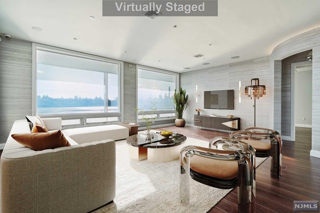 Discover a uniquely crafted and combined penthouse enhanced with luxurious upgrades and detailed finishes at the Glasshouse, the waterfront condo in Edgewater. Features a gourmet kitchen with high-end appliances set against a stunning glass-top island and exotic African Zebra Wood cabinets. Handcut walnut hardwood flooring infuses warmth and personality. Embrace indoor-outdoor living on the expansive wrap-around terrace with panoramic NYC skyline views. Privacy is assured with floor-to-ceiling electrochromic glass. Primary bedroom with a private Manhattan view, spacious closet, and en-suite bathroom featuring an imported copper bathtub, dual showers, and vanities for an oasis of comfort. Enjoy a customized atmosphere with the Lutron lighting and Sonos sound systems. Glasshouse provides a great selection of amenities and a shuttle bus to Ferry. 4 parking included. This penthouse is more than a home; it's a lifestyle.