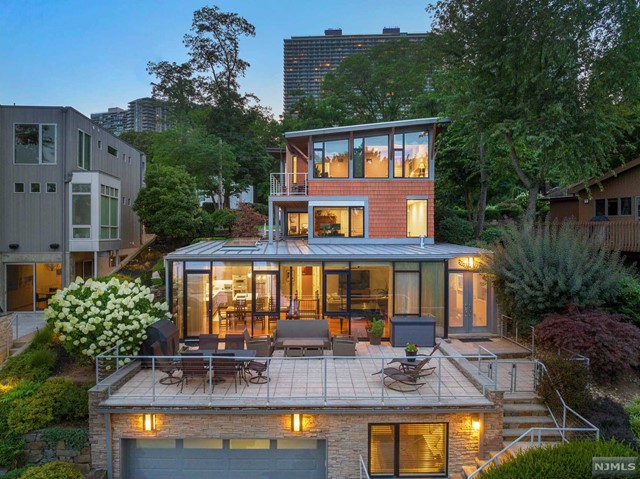 *Watch the comprehensive virtual tour video!* Located just across the Hudson River, the Edgewater Colony offers a tranquil retreat from the stress of NYC with breathtaking views of the Manhattan skyline & the George Washington Bridge. The Colony is peaceful and serene with beautiful foliage, walking paths and spectaculars views along the Hudson River. The Edgewater Colony is located adjacent to the Southern portion of the 2,500 acre Palisades Interstate Park offering hiking, biking, a large children's playground, and additional outdoor activities. This Extraordinary Home features a spacious open floor plan, floor to ceiling windows, & many recent renovations including a new Thermador/Cesar kitchen, new flooring, & more. Off street parking for 6 cars. Front door is actually on Annett Ave. It's a great place to live...with welcoming neighbors in a charming setting....a hidden oasis close to New York City. The virtual tour has a comprehensive video, floor plans, 3d model & more
