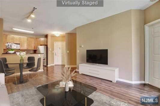 Enjoy partial Hudson River views from this beautifully appointed 1bed/1bath home in the prestigious Hudson Club. Situated as a corner unit with the courtyard, this home has great privacy and great exposure. Open style main floor area featuring stainless steel appliances and granite countertops that flow to the dining and living room right to your private balcony. Large bedroom with walk-in closet and direct access to the bathroom. Enjoy the convenience of the in-unit W/D and 1 car parking outside. Monthly Maintenance includes all utilities and cable/internet except electric. Hudson Club features a large array of amenities including Pool, Concierge, Clubhouse with Fitness Center, Business Center, Basketball Court, Cinema Room, Community Lounge, firepits, electric charging station and more. Located down the street to the Ferry and Light Rail, Ferry Shuttle Service, NJ Transit Bus and Grocery Store/Starbucks/restaurants close by.