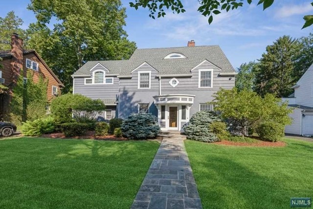 Bright and Spacious Center Hall Colonial on a beautifully landscaped oversized property located in the West Englewood neighborhood of Teaneck. First floor offers a formal living room with fireplace, formal dining room, modern eat in kitchen with high ceilings and plenty of natural light. Breakfast area and family room overlook the private oversized yard. Second level features a master suite complete with a master bathroom with whirlpool tub and steam shower. This level also includes three additional bedrooms including one with an en-suite bathroom, another full bathroom, and large laundry room. Third floor features two large bedrooms and a full bathroom. Full finished basement with large recreation room, full bathroom, and lots of storage space. This home includes hardwood floors, central air conditioning, radiant heat, 5,000 sq ft house, multiple parting spaces. Walking distance to houses of worship, shops, and transportation. Both garages not included in the rental property.