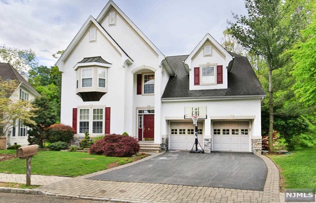 Spacious Sterling model in scenic Ramapo Reserve! The grand 2 story entry foyer has gorgeous h/w floors & lots of closet space. You'll love the beautiful moldings and decorative columns in the living and dining room, perfect for entertaining. Updated kitchen with granite counters, plenty of cabinets, eating area & large pantry, is perfect for any cook! The kitchen opens up the family room with a wall of windows, beautiful views, and access to deck. The 1st floor is complete with a 1/2 bath, laundry room, & 2 car attached garage. Upstairs is a grand master suite w/cathedral ceiling, large walk-in closet, & massive bath w/jacuzzi tub. 3 add'l spacious bedrooms and a full bath complete the 2nd floor. The walkout basement is sunny and bright w/plenty of storage, full bath, and access to patio/landscaped yard. Fabulous location near club house, pool, community room, gym, playground, walking paths, & parking. The perfect place to call home!