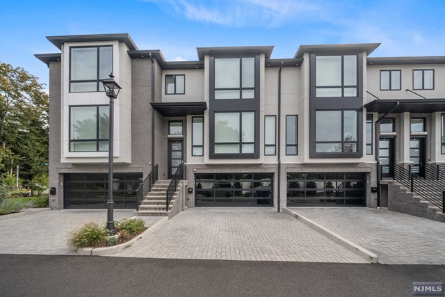 Stunning townhouse in Paramus in a boutique & high-end community w. gorgeous landscaping built 2 years ago. Completely customized unit featuring professional interior designer touches. 3 levels of luxury spaces spanning approx. 3,500 sq ft. Ground Level offers 2car garage w. epoxy flooring & EV charger + den w. bar, 1/2 bath & SGD to patio. Main level continues to impress. Professional Chef's kitchen w. SubZero/ Wolf appliances, waterfall island, & 2 tone cabinetry. Large DR with dramatic black accent wall & trims. Open Concept floorplan with Marble fireplace w. built ins. Trex Deck off of kitchen. Top floor offers 3 Bedrooms & 2 full bathrooms. The primary features en-suite bath w. soaking tub, double vanity & huge glass shower. Double WICs. Security Cameras, Surround Sound, Smart Lock, Smart Shades. Pet may be considered. Avail Sept 15 - available to rent FULLY FURNISHED. Very convenient to highways & NYC. Landscaping / Snow Removal included. Owner is licensed Real Estate agent