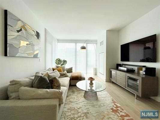 Discover pure modern elegance in the most premier and luxurious new construction building, Nine on The Hudson, located along the desirable NJ Gold Coast waterfront. Enter into this spacious 2 Bedroom / 2 Full Bathroom open layout floor plan covering approximately 1,140 sqft with SOUTHERN exposure and partial views of NYC from the balcony. The expansive kitchen includes Aspen quartz countertops, Pedini cabinets, Bosch appliances, and a Thermador refrigerator open to the living and dining room. Large primary en-suite with a walk-in closet and a generous size second bedroom. Enjoy wood flooring throughout, in-unit washer/dryer, and oversized windows. This beautifully designed luxury building features breathtaking views of NYC with 40,000 sqft of resort-style amenities: 24-hour doorman, state-of-the-art fitness center, amenity deck with infinity swimming pool and BBQ area, rooftop deck with cabanas, shuttle to/from Ferry. Welcome home to Nine on the Hudson!