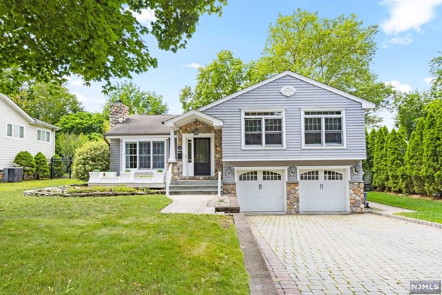 This gorgeous custom-built expanded split is located on Cresskill's east hill, situated on the quiet side of Madison Avenue. The house features an inviting entry foyer that leads into a spacious living room. The dining area is open to a spectacular 20-foot kitchen, boasting a large center island, vaulted ceiling, custom cabinets, a 48' refrigerator, and double wall oven, a warming drawer, and a wine refrigerator. Upstairs, you'll find the luxurious master bedroom suite with a large walk-in closet, a master bath complete with a Jacuzzi tub, vaulted ceiling, and skylight. There are two more generously sized bedrooms with ample closet space. The lower level features a den, laundry area, and convenient entry to the two-car garage. Additionally, the finished basement offers a recreation room, a half bath, and excellent storage options. This home has been meticulously maintained, making it an exceptional find on Cresskill's east hill.