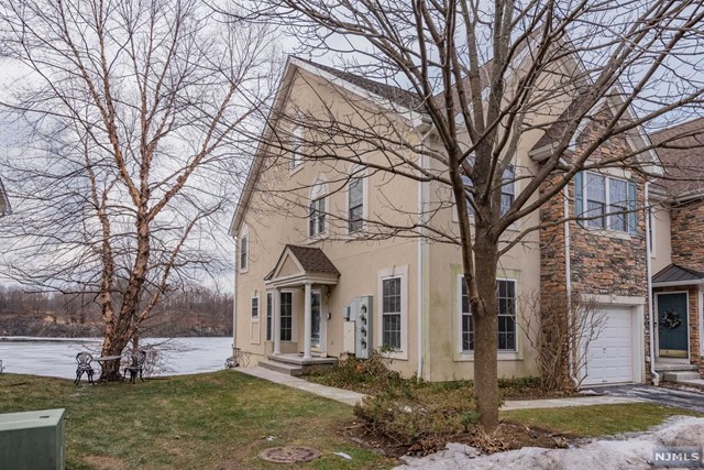 IF you've been waiting for a lakefront end unit with stunning views and a walk out lower level....your search is over! Welcome to Lakeside of North Haledon, a beautiful resort style community loaded with amenities! This 3 BR 2.5 BTH Bucknell Model is drenched with natural light. FLR & DR w/wood floors, 2 story family rm w/gas fireplace open to EIK w/custom back splash, granite countertops and SS Appliances. MBR has balcony overlooking the lake, wood floors, tray ceiling, his/hers WIC's and MBTH w/jacuzzi tub, double sinks and SS. Two add'l BR's, FBTH and Laundry Room complete the 2nd level! Finished walk out lower level adds over 1000 sq ft of living space and plenty of storage. Freshly painted, built in vac & alarm sys. Clubhouse w/gym, heated pool & hot tub, tennis and lake w/boating & fishing! Convenient to Highways & shopping, easy commute to NYC! ALL OFFERS /BEST & FINAL BY 5:00 PM MONDAY 1/31