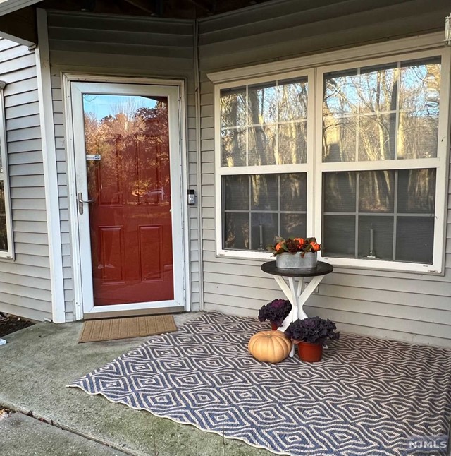 Step into your private, corner unit in the desirable The Glens Community. Enjoy the view of the large wooded area right from your front patio porch. Open concept living room, dining room, and kitchen. The kitchen is renovated with stainless steel appliances, breakfast bar, granite counter tops, and a pantry closet. Primary bedroom is spacious and has a walk in closet, plus a bonus closet. Bathroom is also renovated and has a granite counter top vanity. Guest bedroom completes the unit and both bedrooms have wooded area views as well. Washer and dryer in unit, and floating hardwood floors throughout, AC was replaced two years ago. This well maintained condo is in move in condition. Enjoy all that The Glens Community has to offer, 2 pools, clubhouse, tennis courts, children's playground, overall great community living.